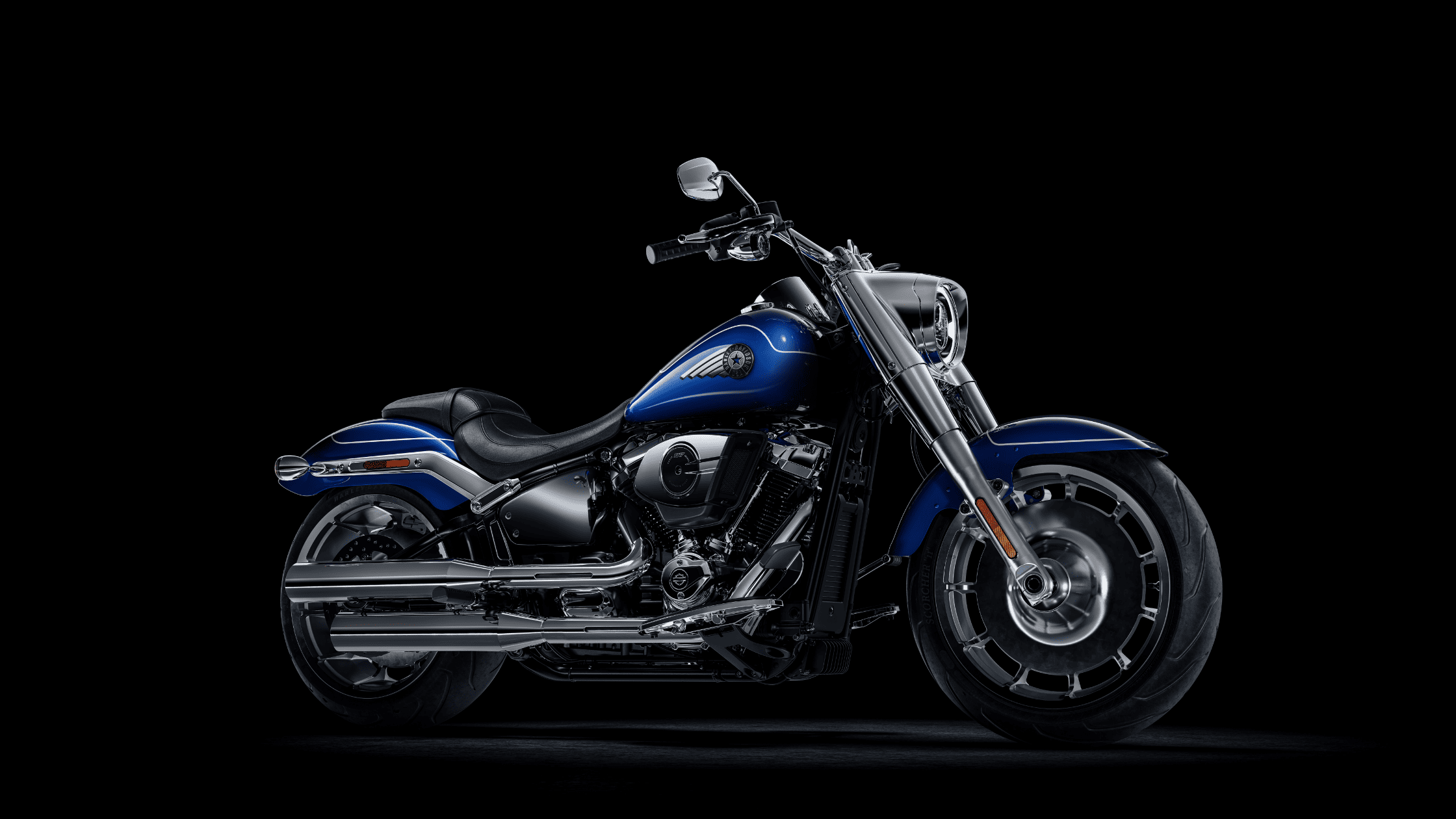 Angled view of a blue and chrome 2025 Harley-Davidson® Fat Boy® cruiser motorcycle.