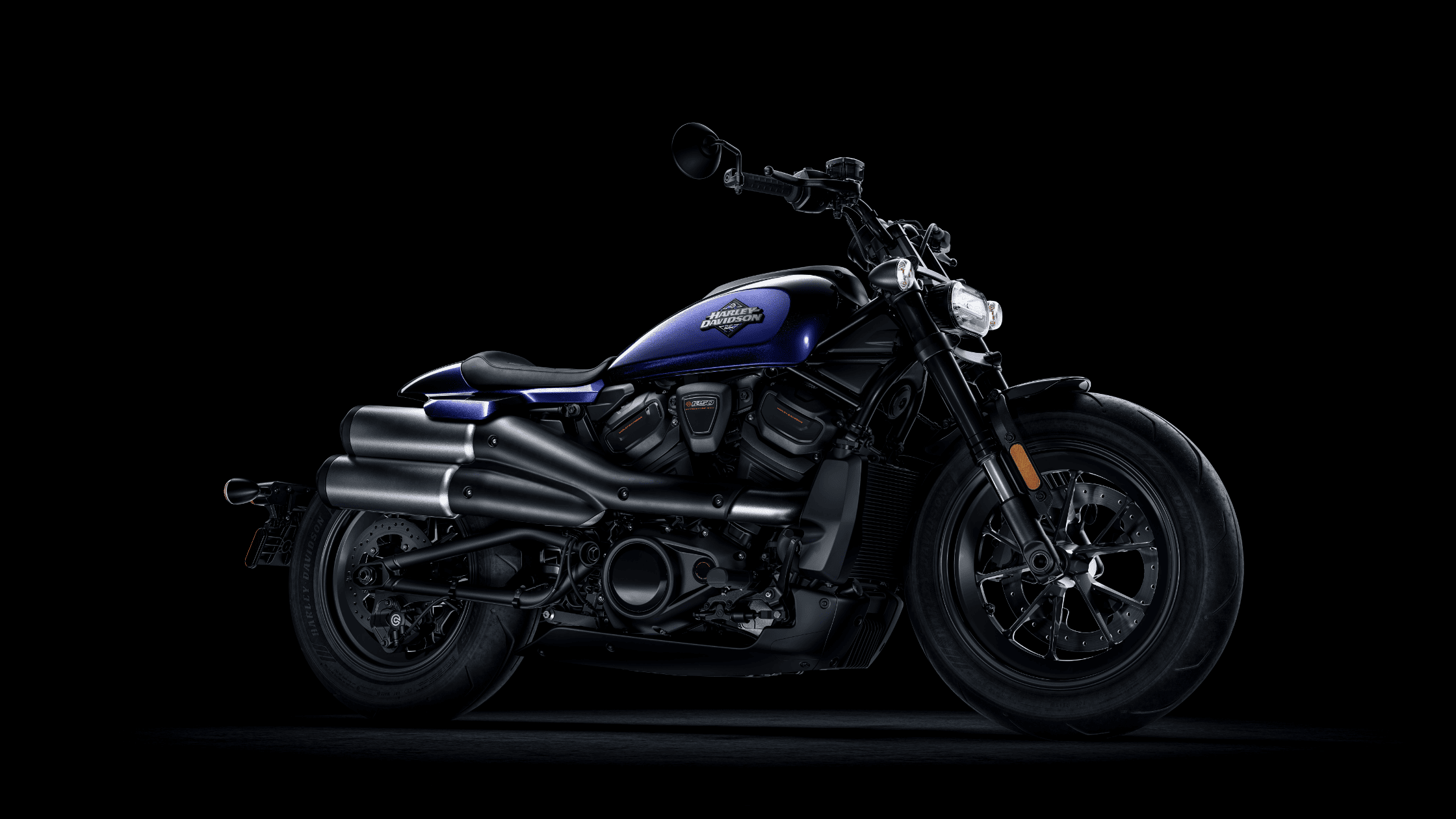 Angled view of a blue and black 2025 Harley-Davidson® Sportster® S performance cruiser motorcycle.