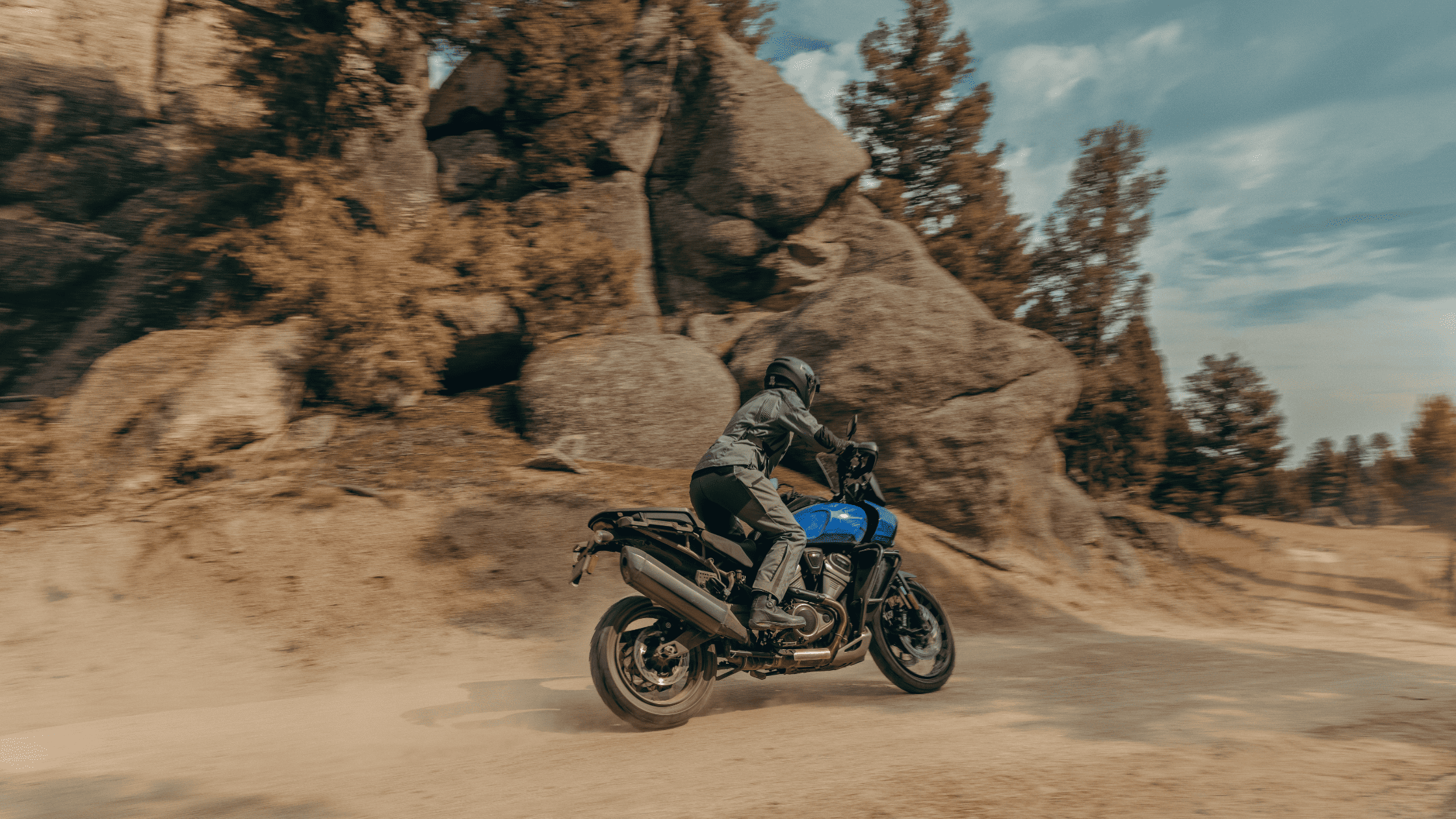 Off-road adventure on 2025 Harley-Davidson® Pan America 1250 Special near large rocky outcrops.
