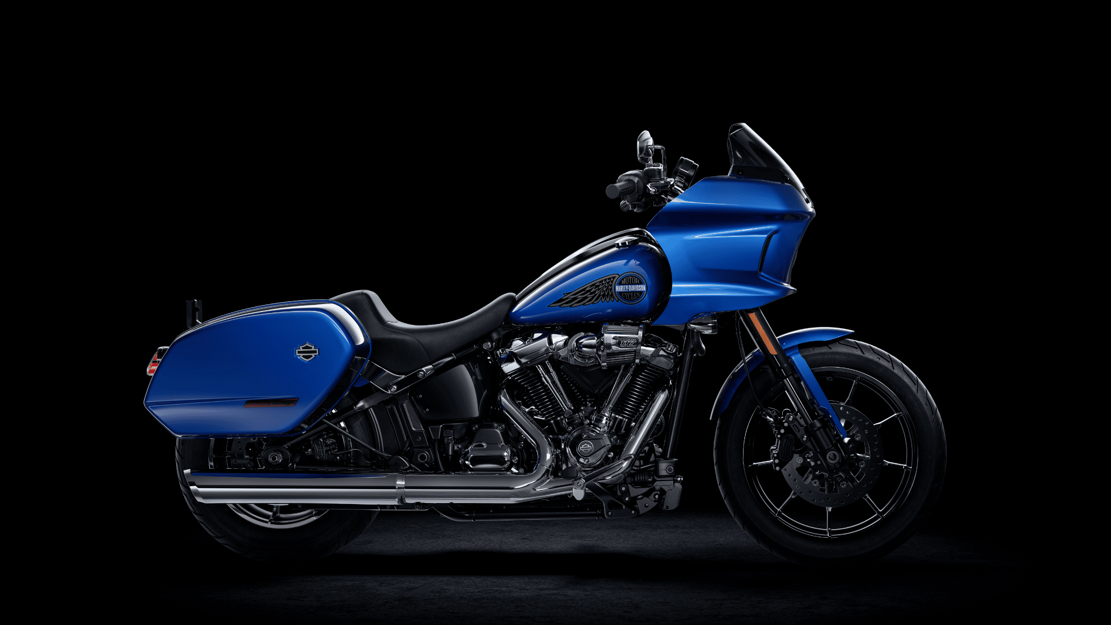 Side view of a blue 2025 Harley-Davidson® Low Rider® ST sport-touring motorcycle on black background.