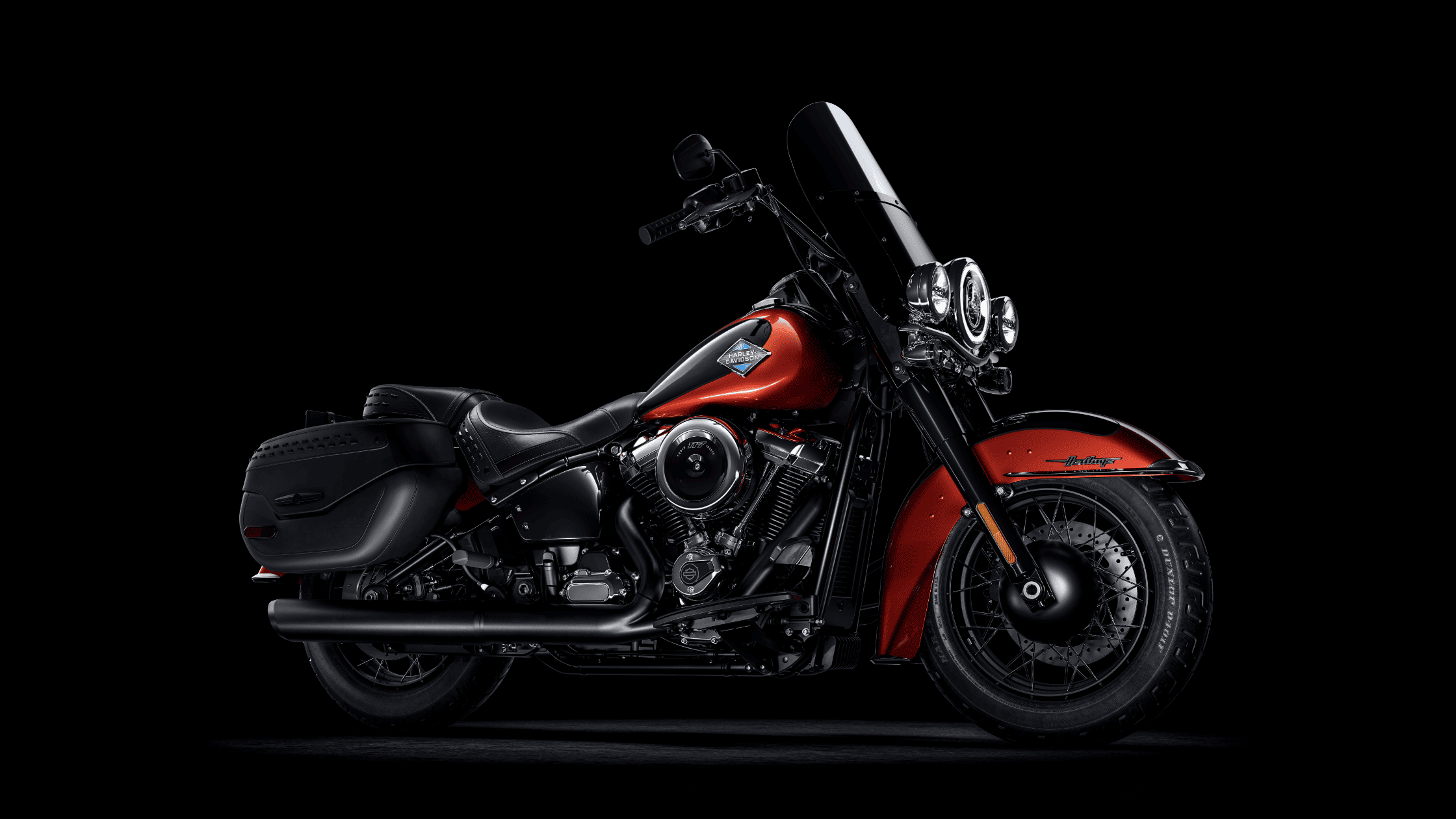 Angled view of a red and black 2025 Harley-Davidson® Heritage Classic touring cruiser motorcycle.