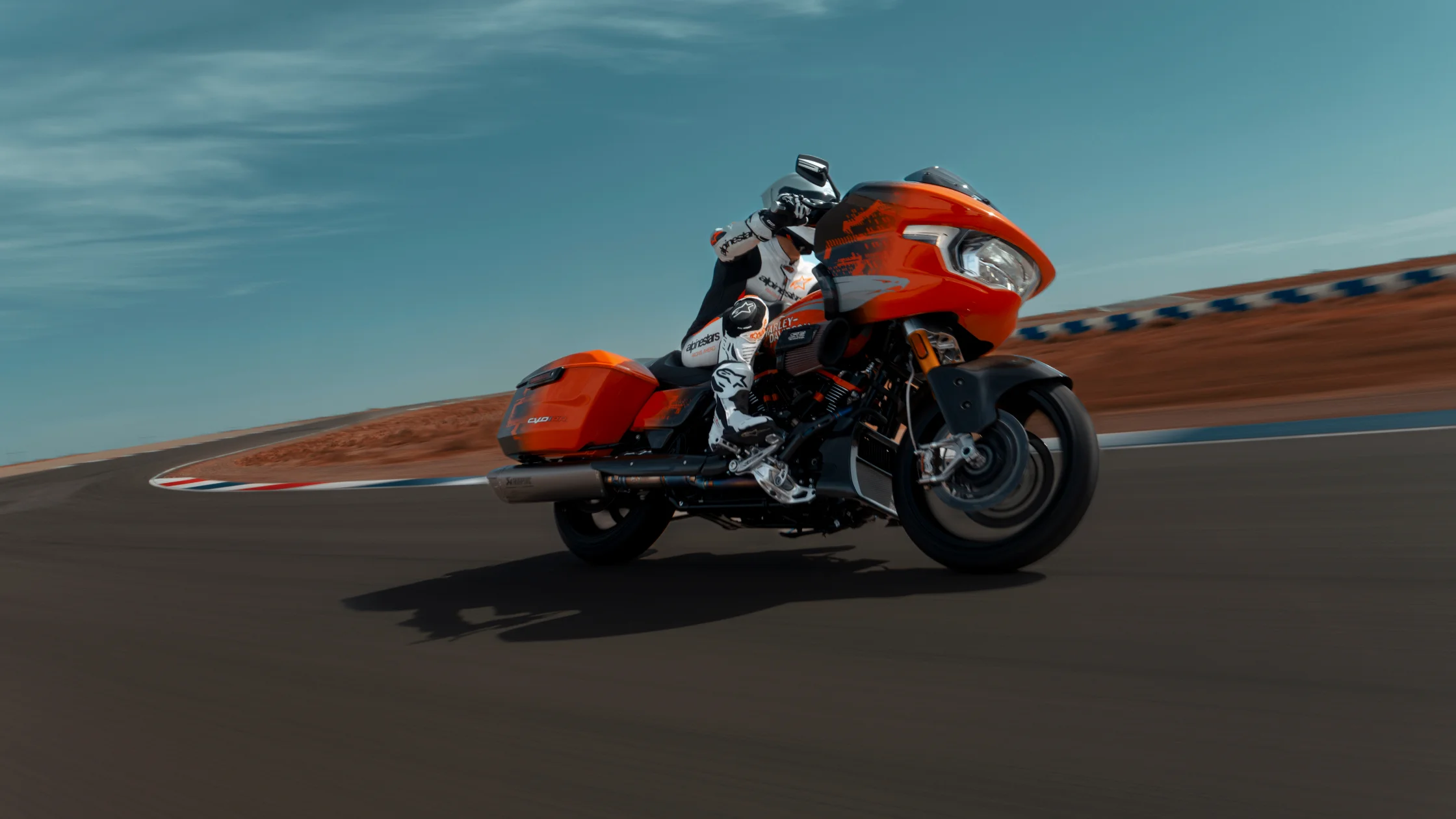 2025 Harley-Davidson® CVO™ Road Glide® RR racing on track with rider leaning into the curve.