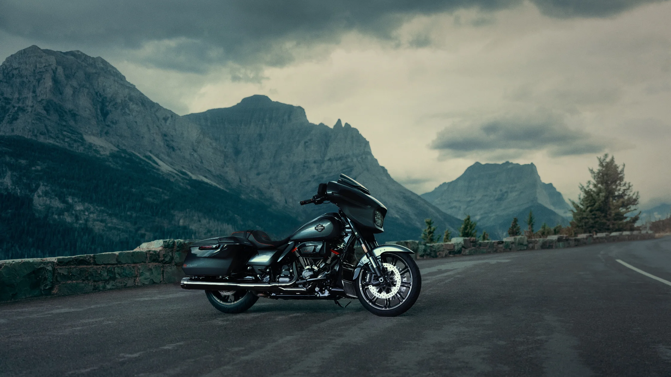 2025 Harley-Davidson® CVO™ Street Glide® motorcycle parked on a scenic mountain overlook under cloudy skies.