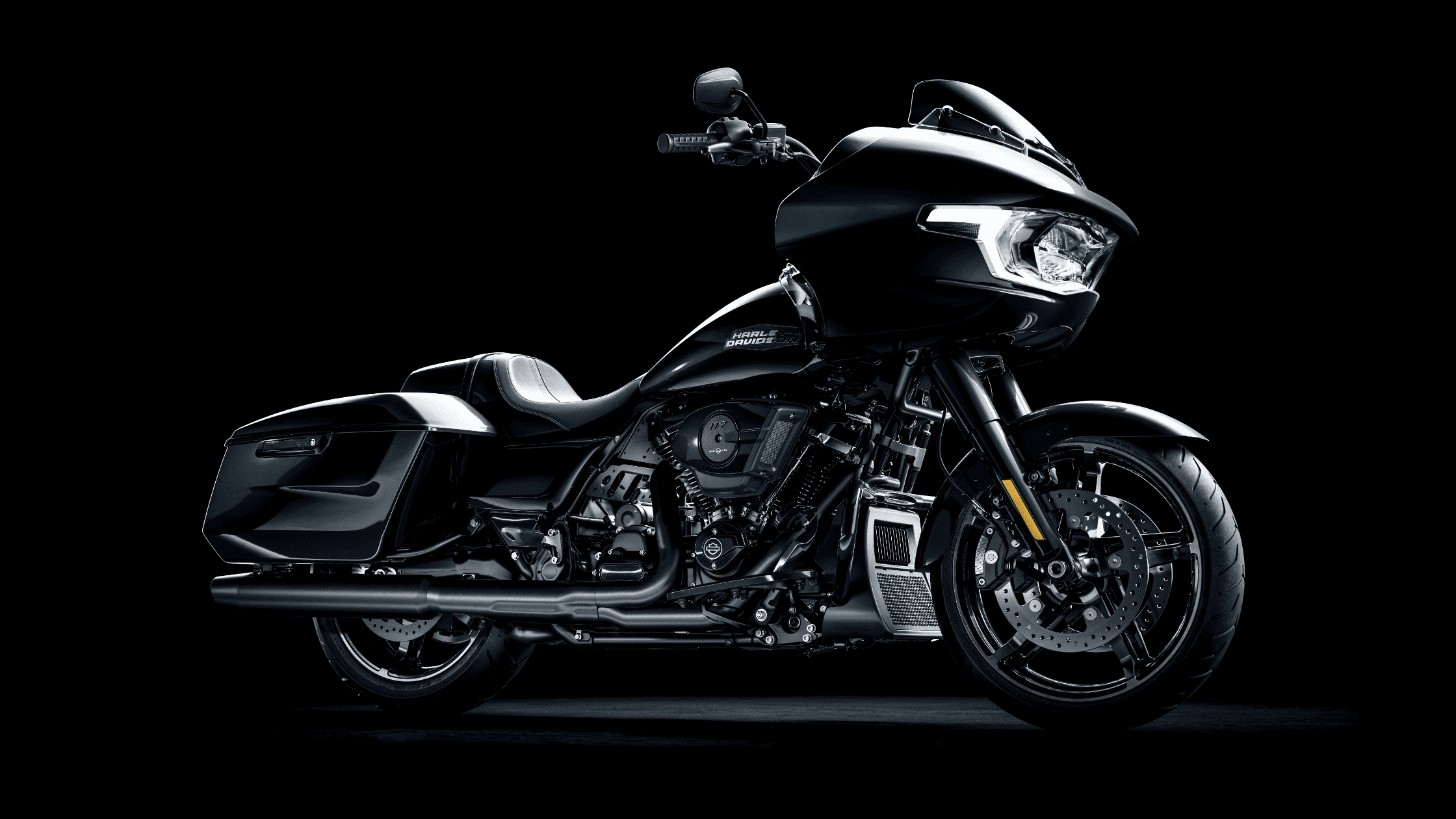 2025 Harley-Davidson® Road Glide® in sleek black, parked in studio light, showcasing its aggressive touring design near McDonough, GA.