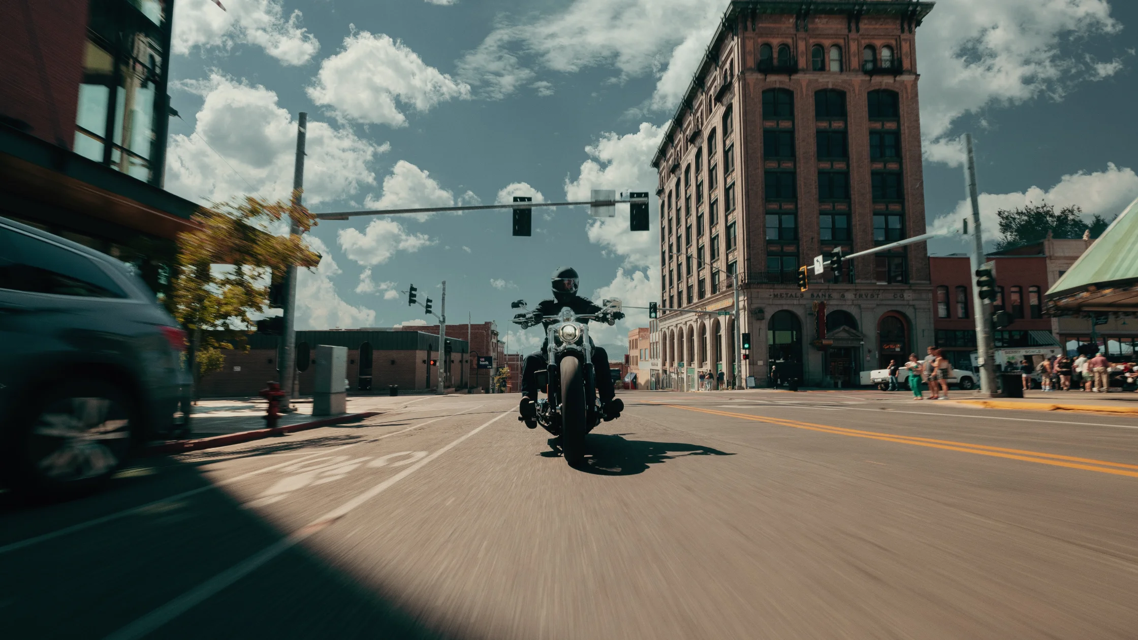 Rider on 2025 Harley-Davidson Breakout® cruising through an urban intersection, head-on view