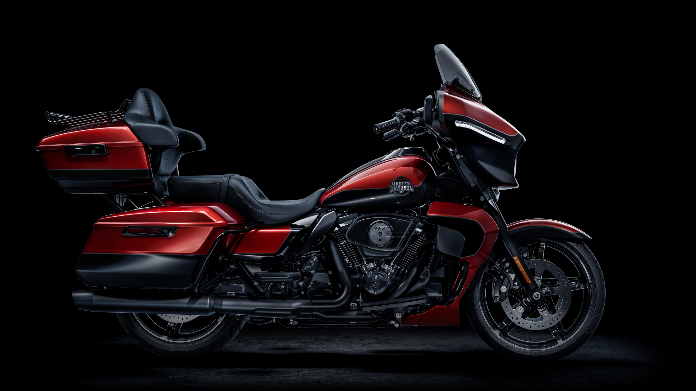 2025 Harley-Davidson Street Glide Ultra in red and black finish, side profile view on a dark studio background.
