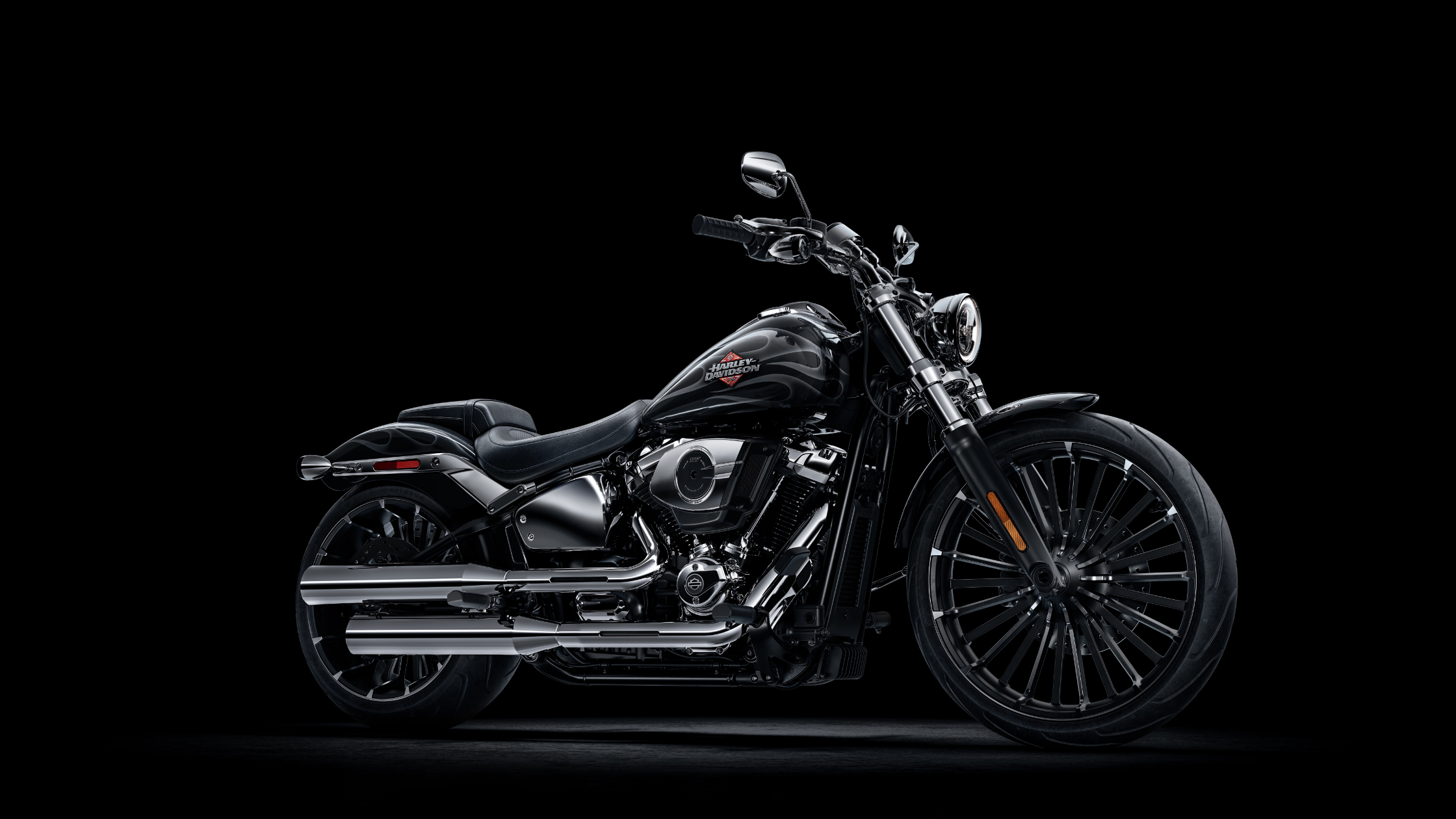 2025 Harley-Davidson Breakout in glossy black with chrome accents, angled studio shot on dark background.