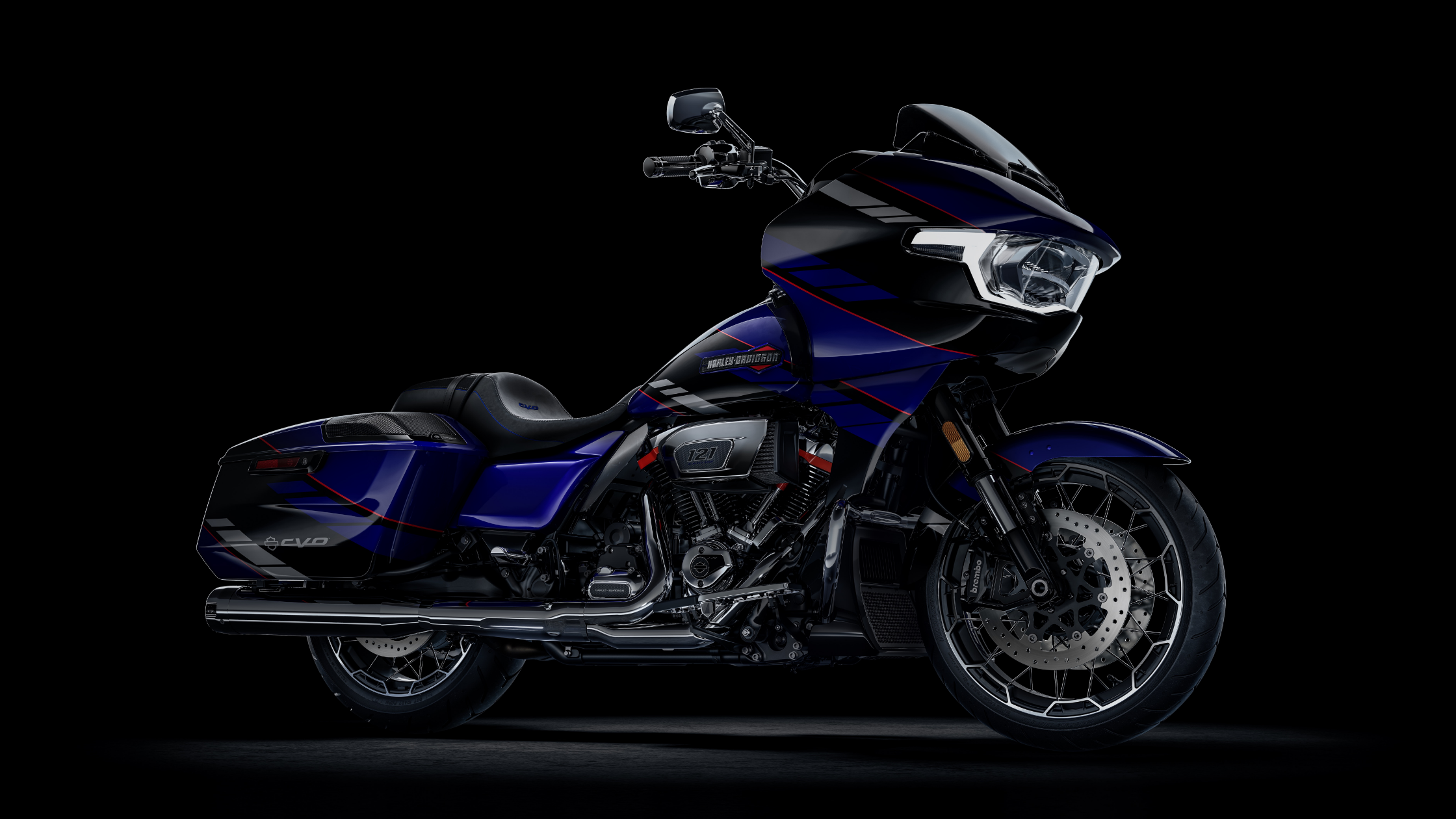 2025 Harley-Davidson CVO Road Glide in blue and black with red accents, side view on a dark studio background.