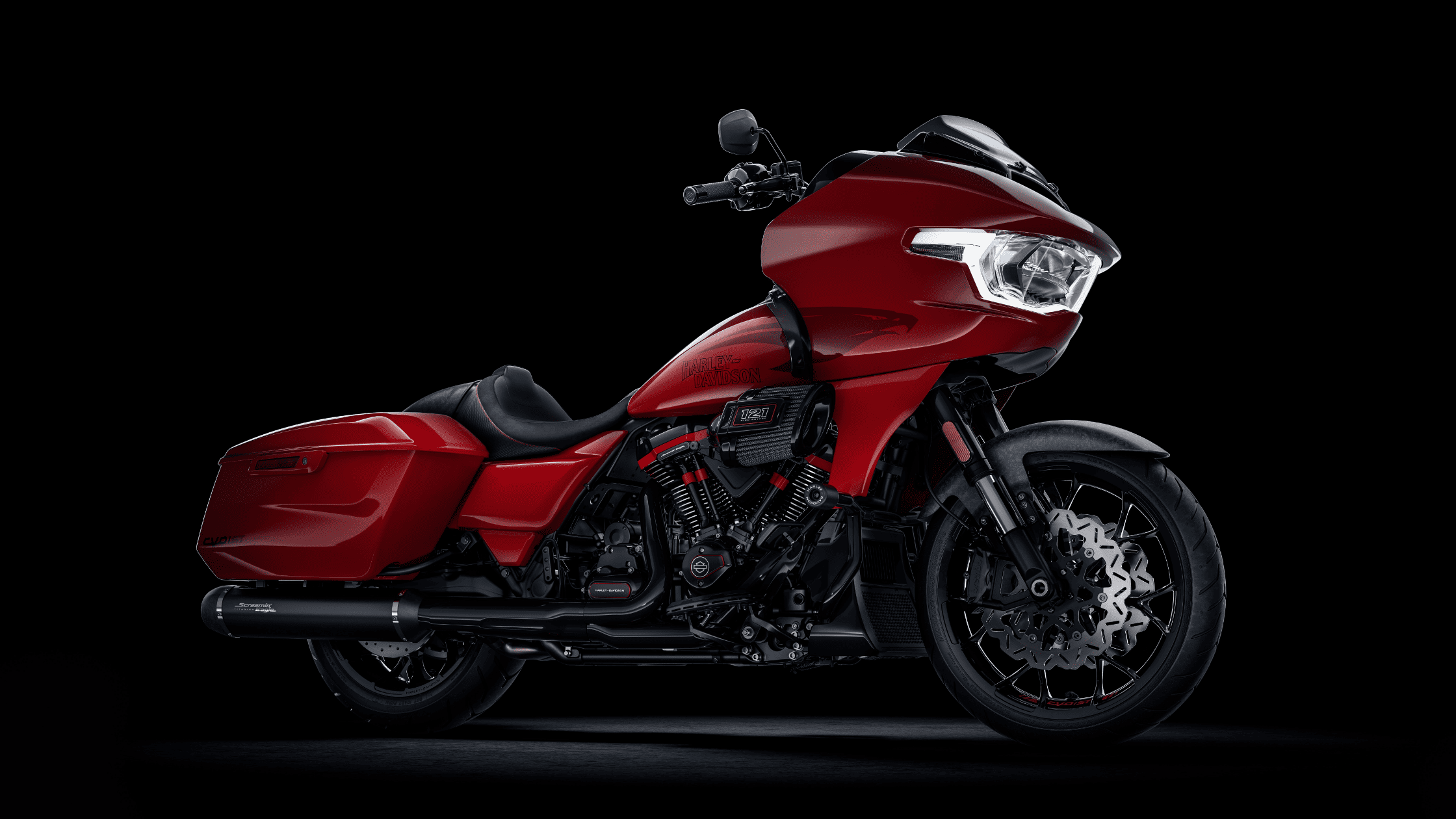 2025 Harley-Davidson® CVO™ Road Glide® ST in red with performance exhaust, Milwaukee-Eight® 121 V-Twin engine, and aerodynamic fairing.
