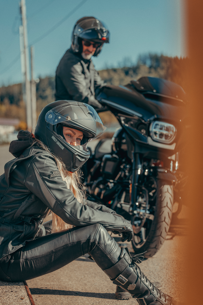 Harley-Davidson riders in full gear next to a Street Glide