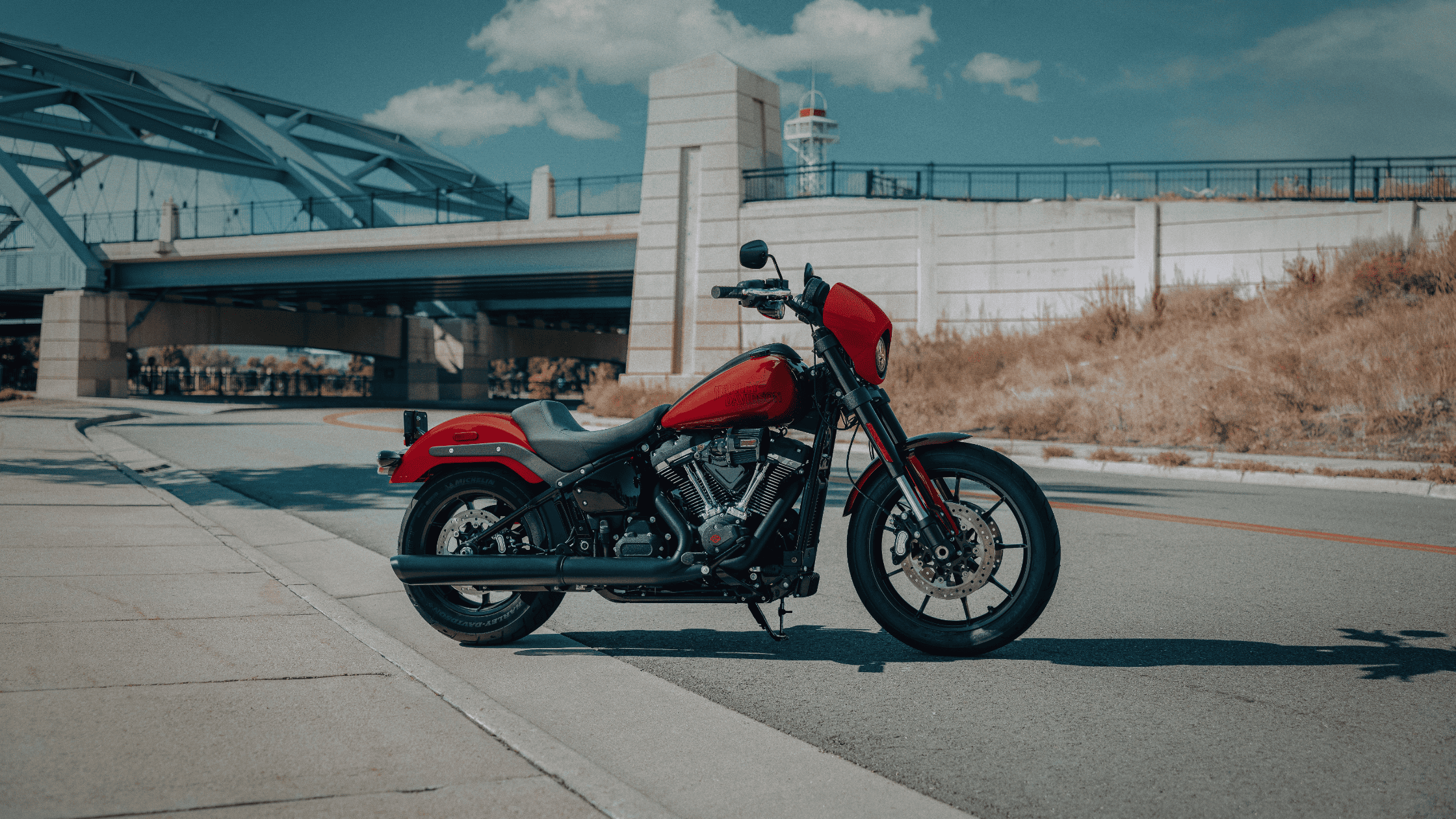 2025 Harley-Davidson® Low Rider® S in bright red parked under a city bridge near McDonough, GA.