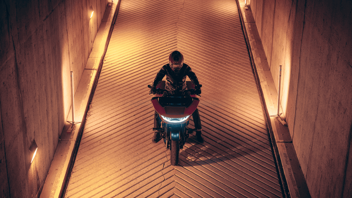 Front view of a rider on a 2025 Harley-Davidson® CVO™ Road Glide® ST in a tunnel near Sanford, FL, showcasing its aggressive stance & LED lighting.