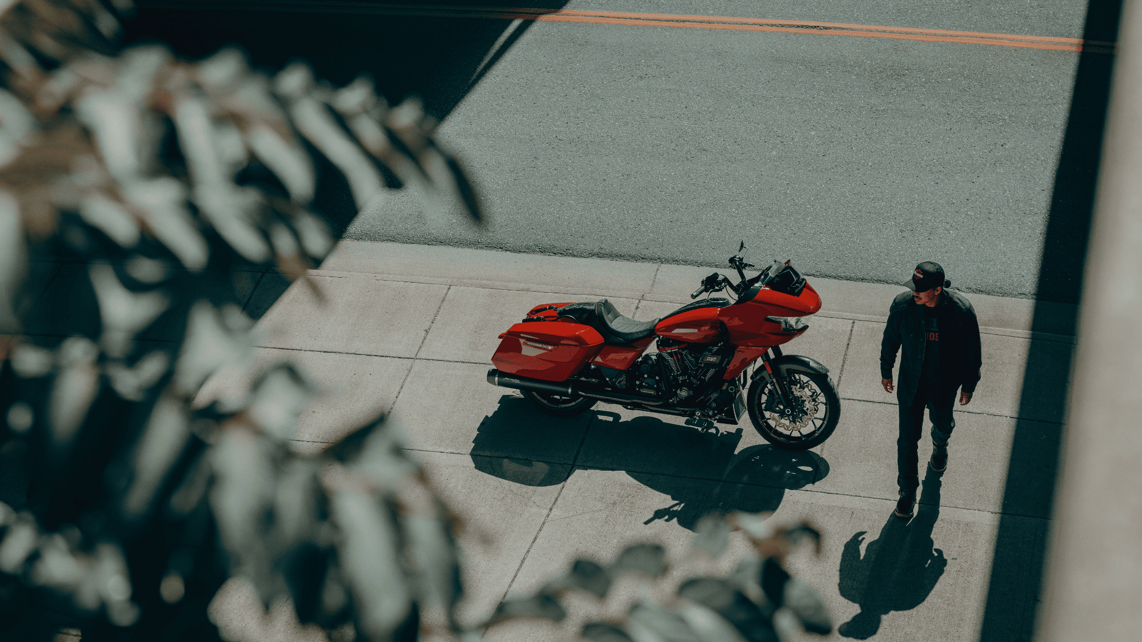Rider on black 2025 CVO Road Glide ST speeding highway, touring fairing with aggressive stance