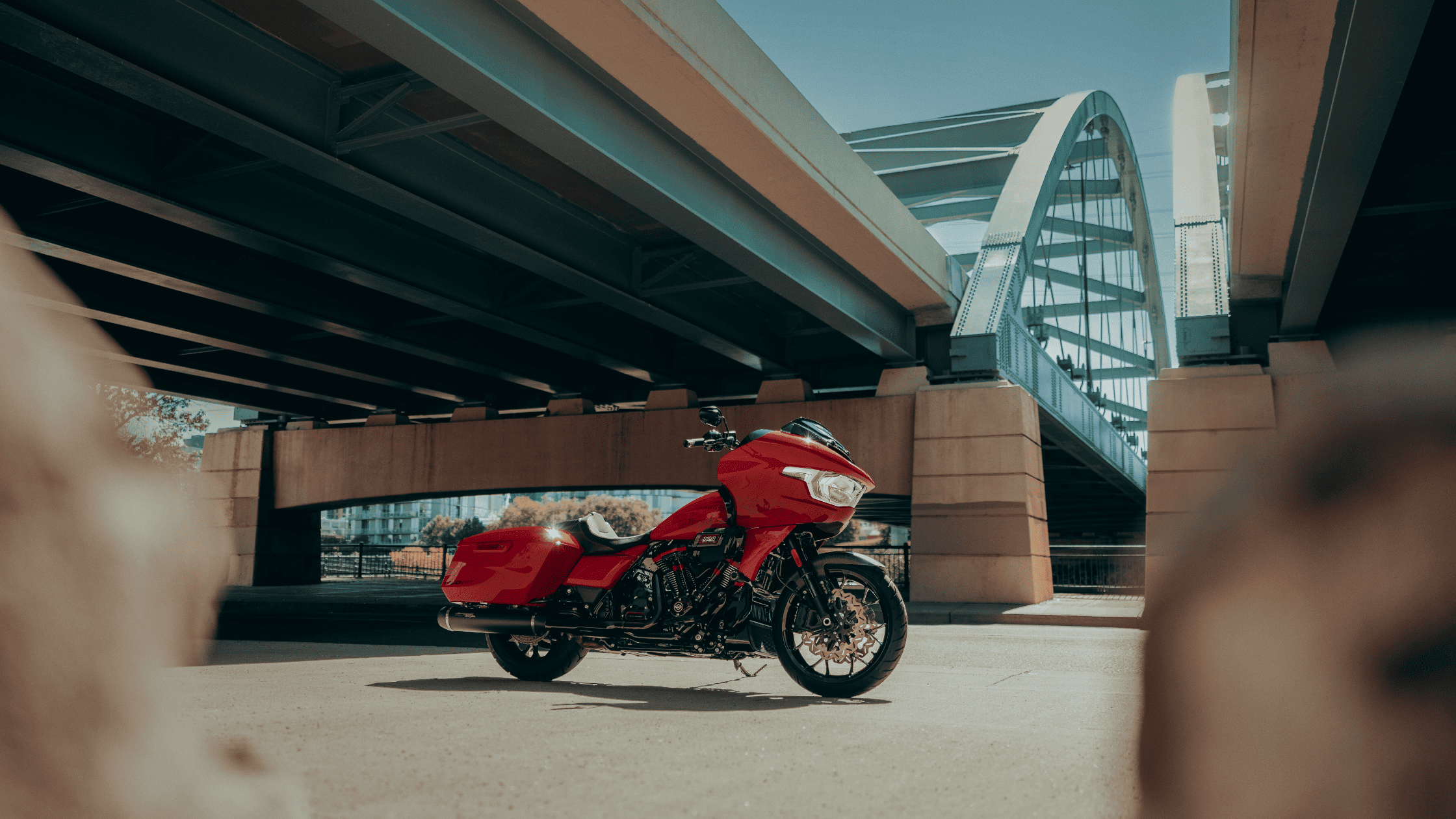 2025 CVO Road Glide ST in red parked under modern bridge structure