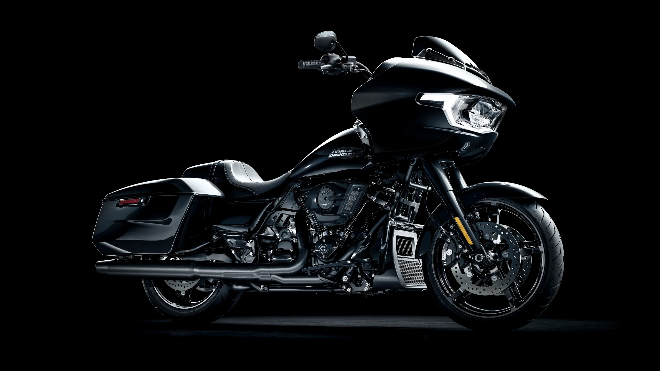 A 2025 Road Glide in black finish with sleek saddlebags, LED headlamp, and batwing fairing design.