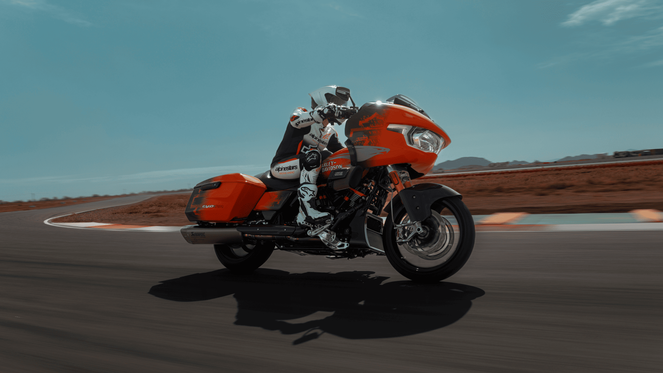 2025 Harley-Davidson® CVO™ Road Glide® RR in orange racing on track near Atlanta GA highlighting performance styling.