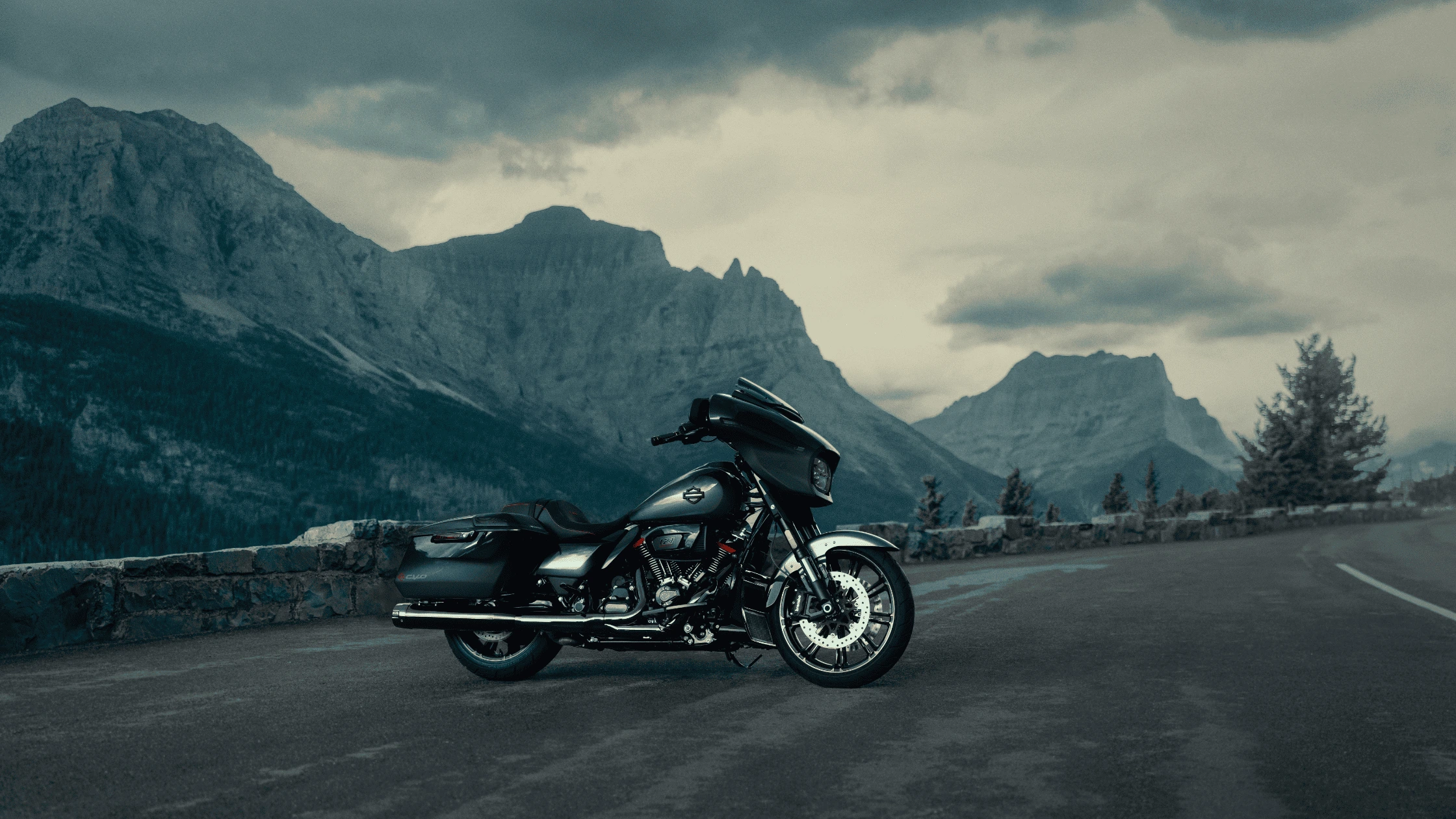 2025 Harley-Davidson® CVO™ Street Glide® in dark custom finish, set against dramatic mountain backdrops near McDonough, GA, showcasing luxury touring power.