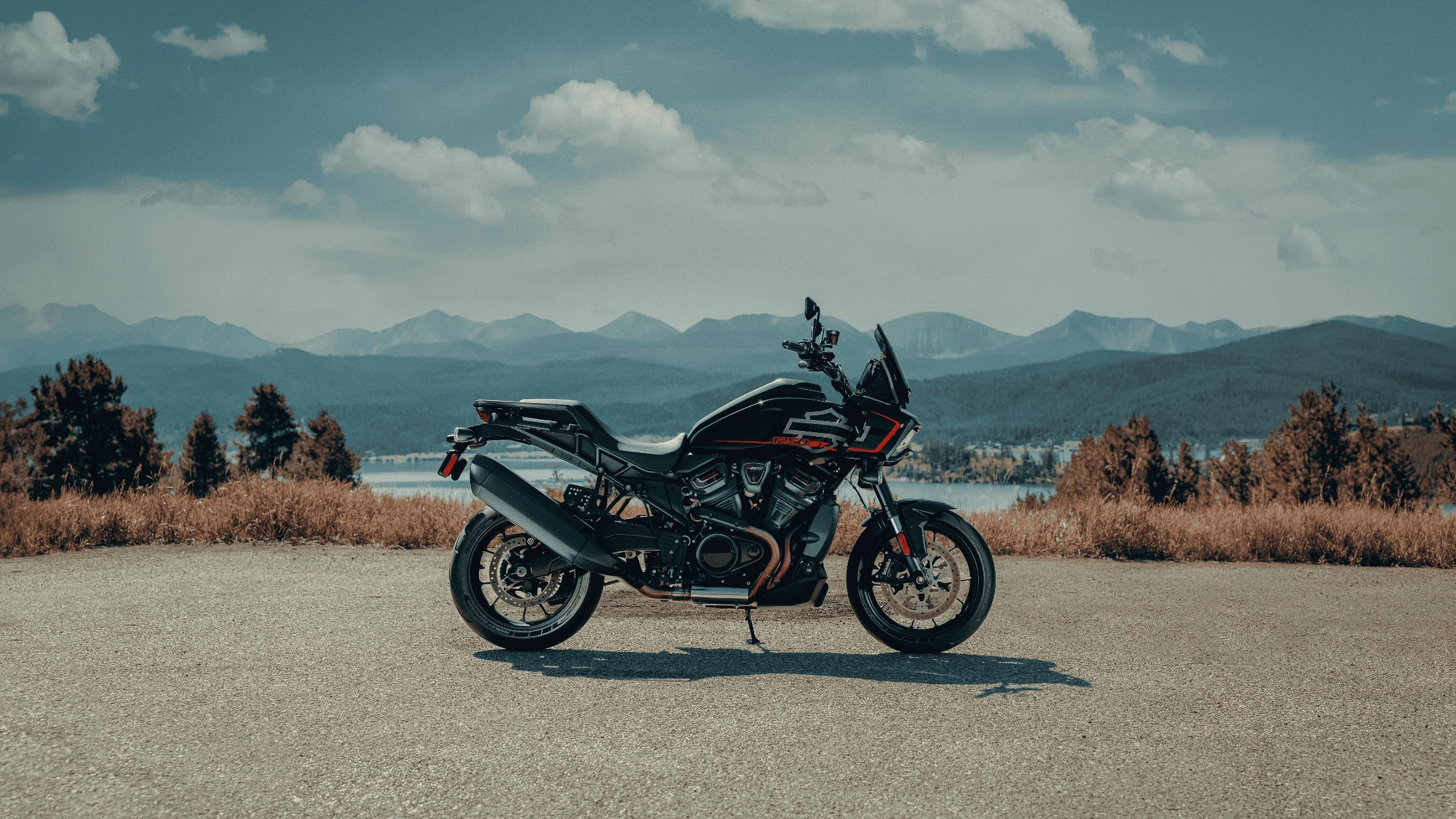 2025 Harley-Davidson® Pan America® 1250 ST in sleek black, shown in a scenic mountain overlook near Bentonville, AR.