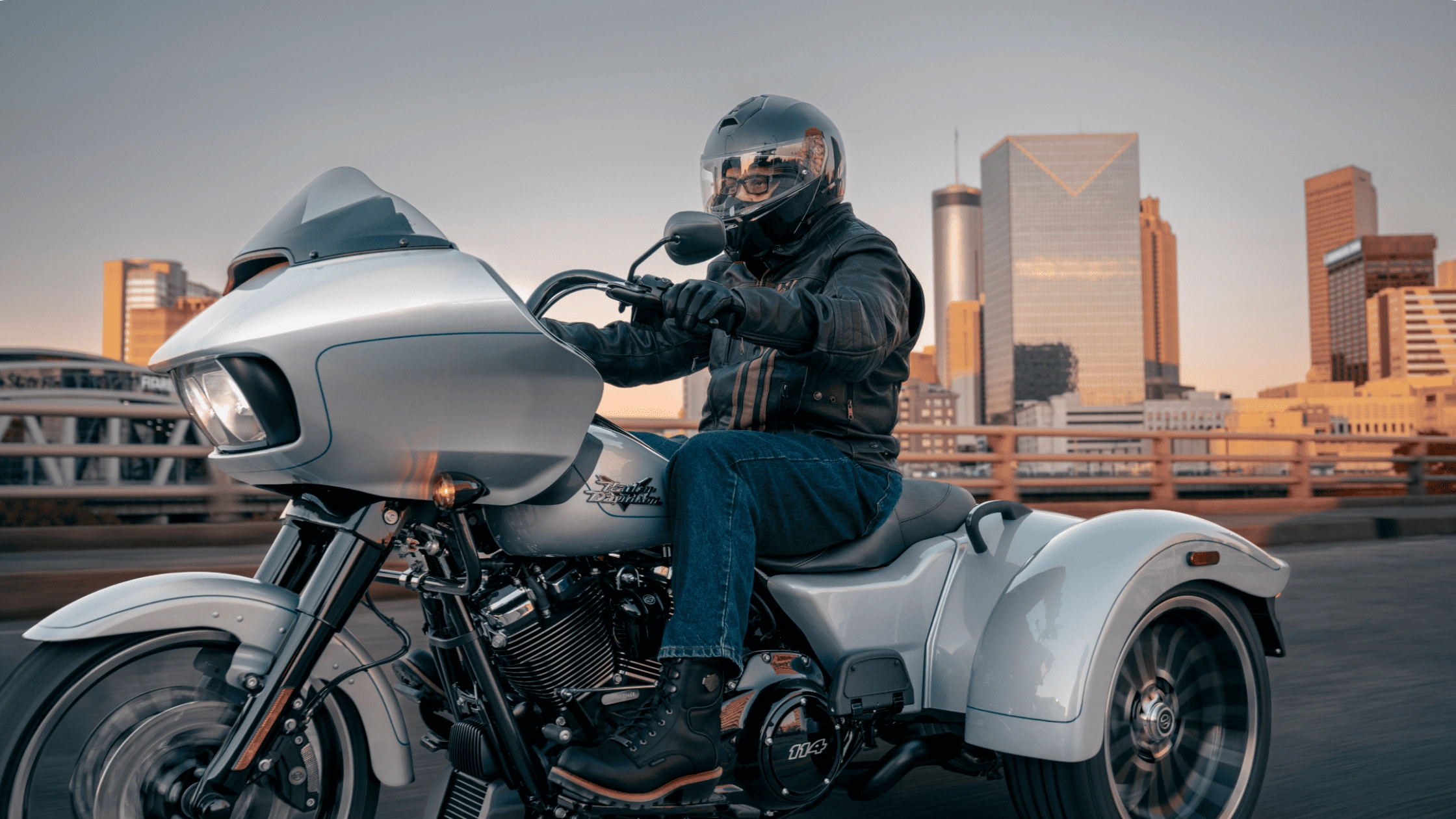 Rider cruising a 2025 Harley-Davidson® Road Glide® 3 near Bentonville, AR, showcasing bold front fairing and three-wheel performance design.