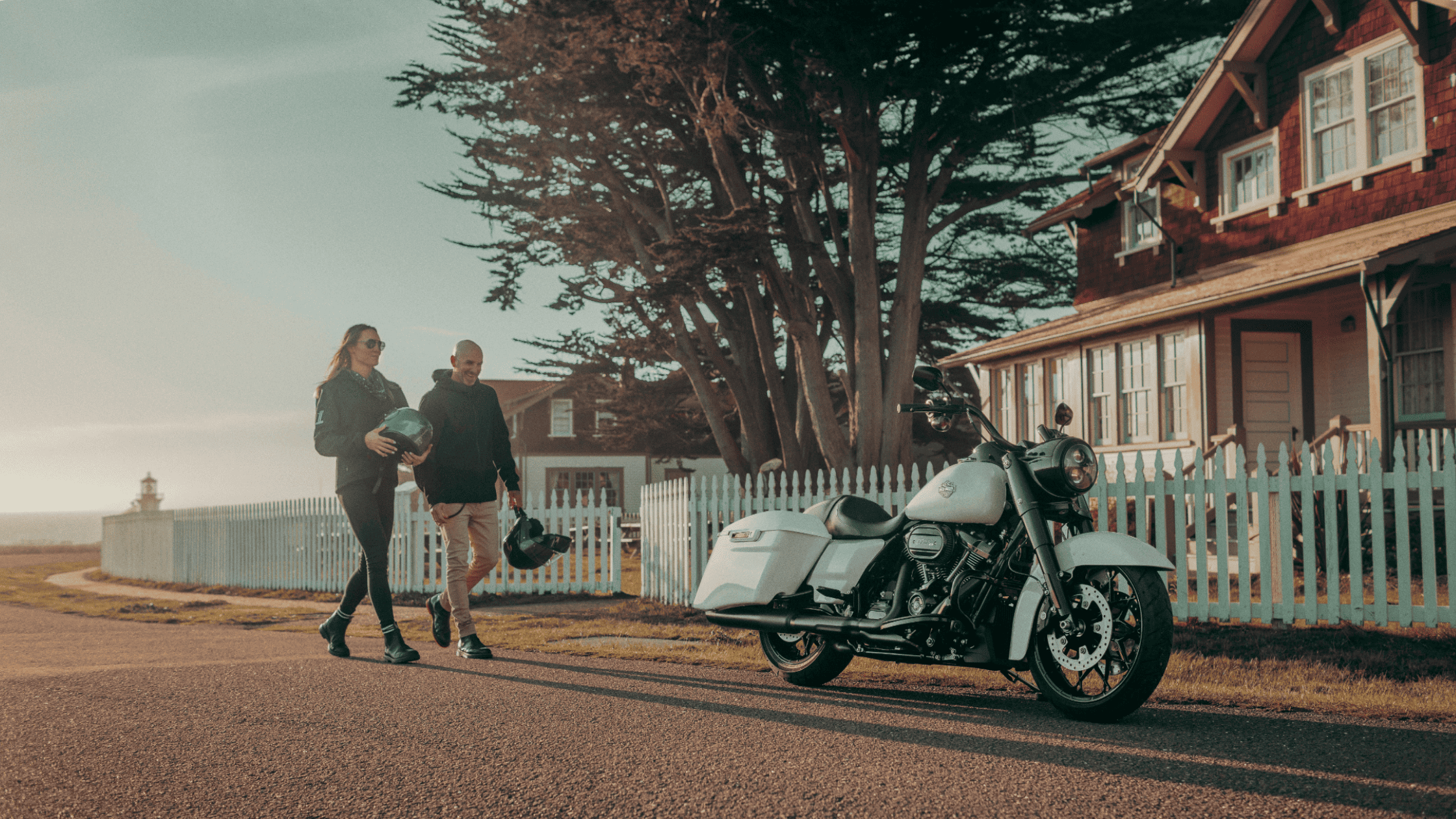 The 2025 Harley-Davidson® Road King® Special parked near a coastal home captures its classic bagger design with blacked-out details, Milwaukee-Eight® 114 engine, and signature touring stance.