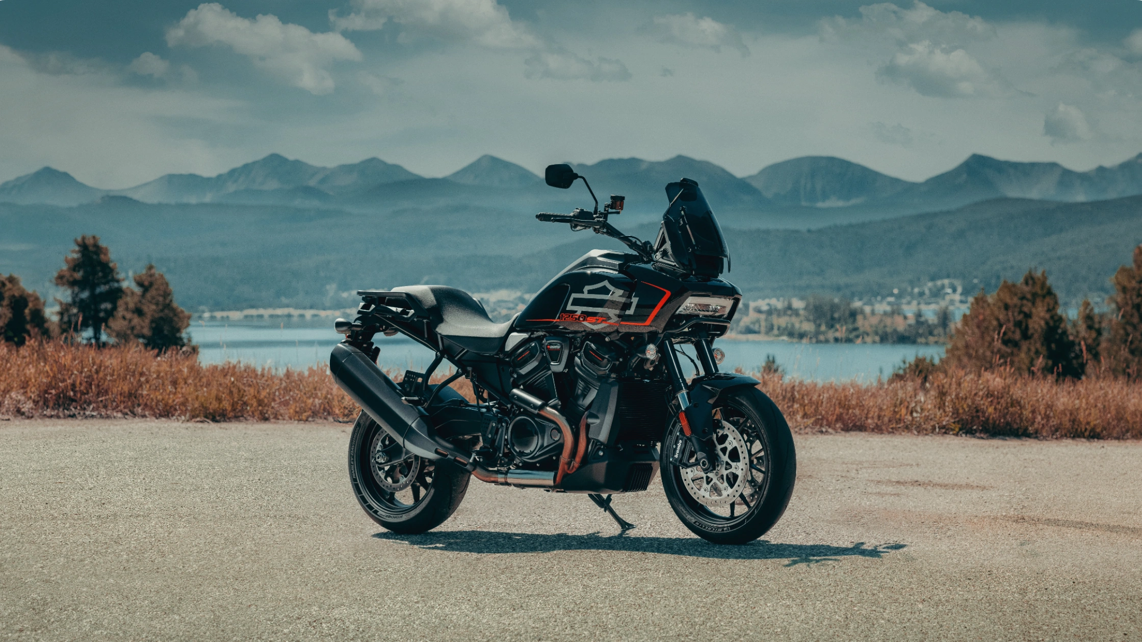 2025 Harley-Davidson Pan America 1250 ST motorcycle on open mountain road with panoramic backdrop.