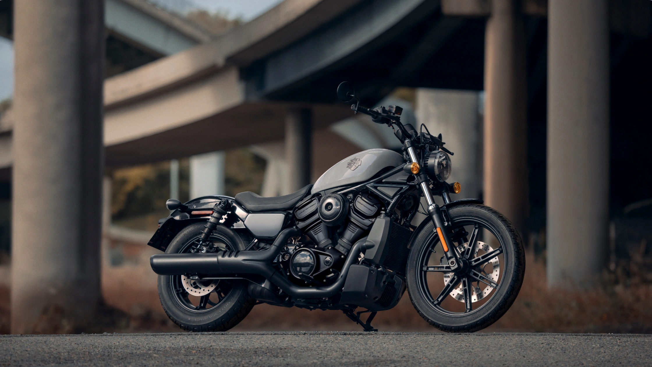 2025 Harley-Davidson® Nightster® parked under bridge highlighting its modern cruiser design.