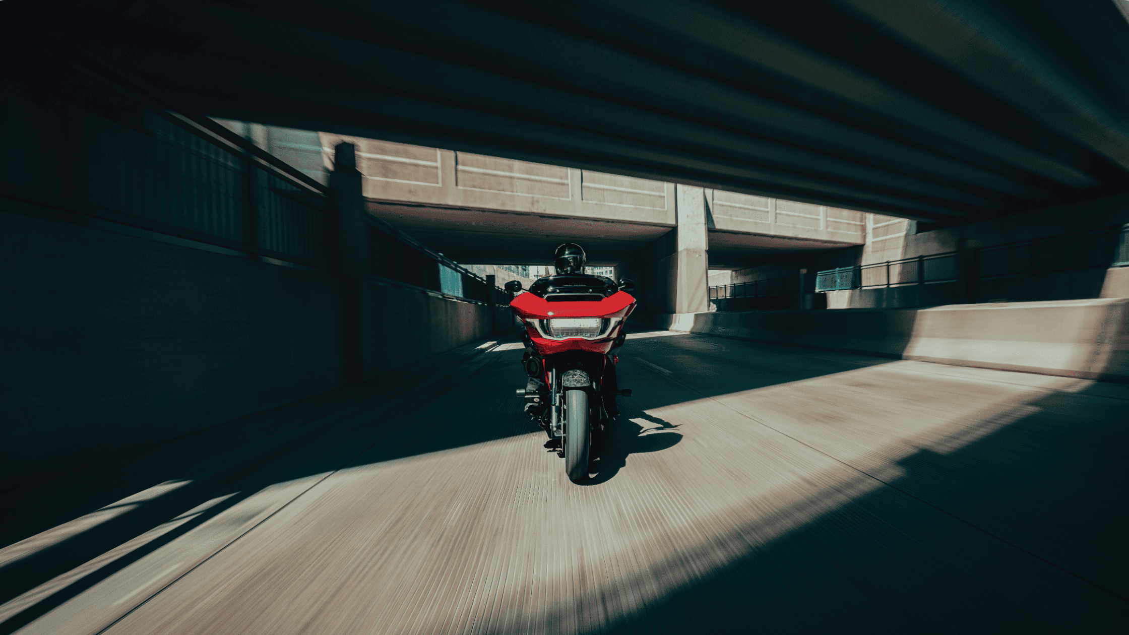 2025 Harley-Davidson CVO Road Glide ST cruising through a shaded underpass on a bright daytime ride