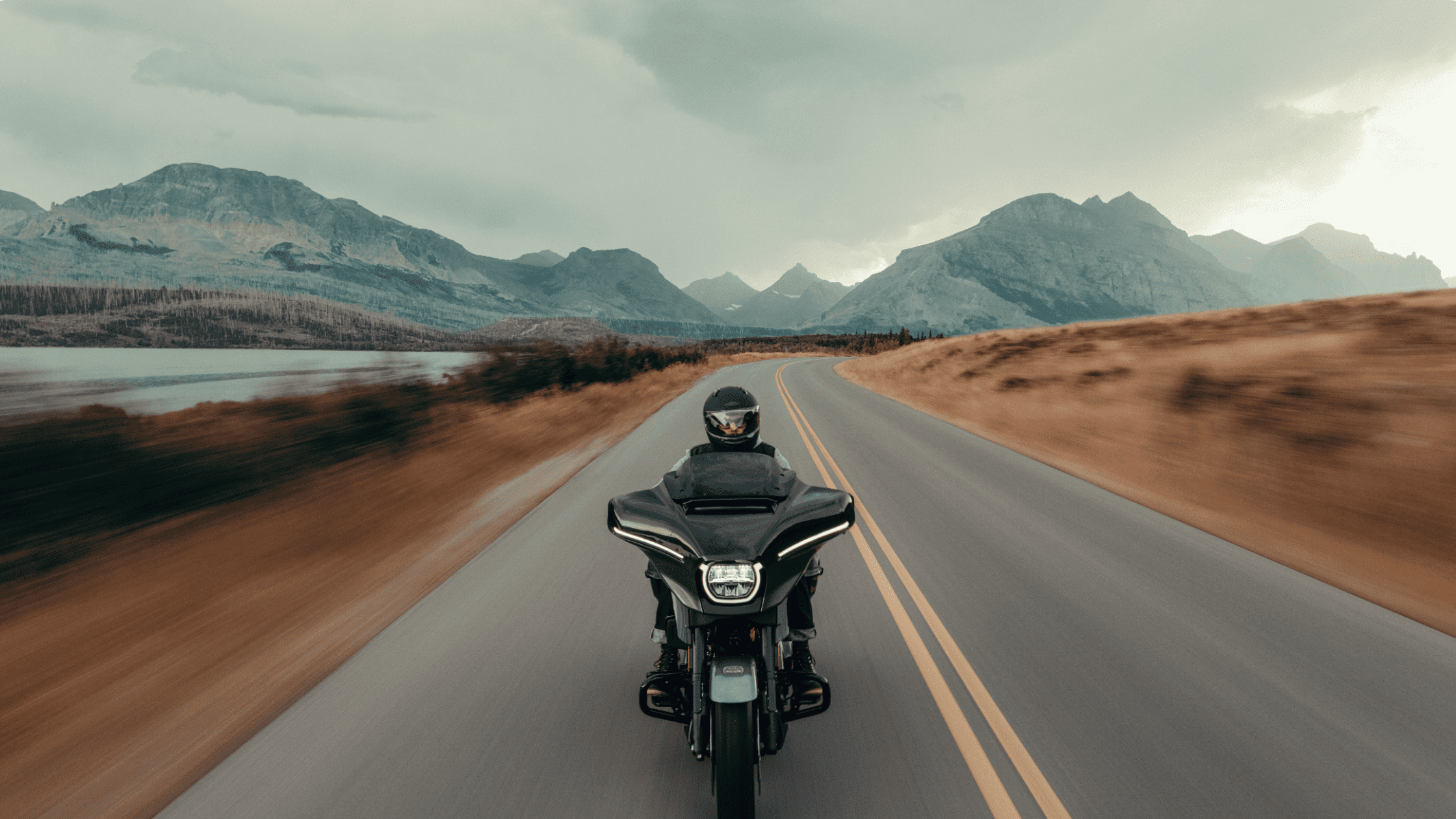 2025 Harley-Davidson CVO Street Glide riding on a winding mountain road with dramatic scenic views