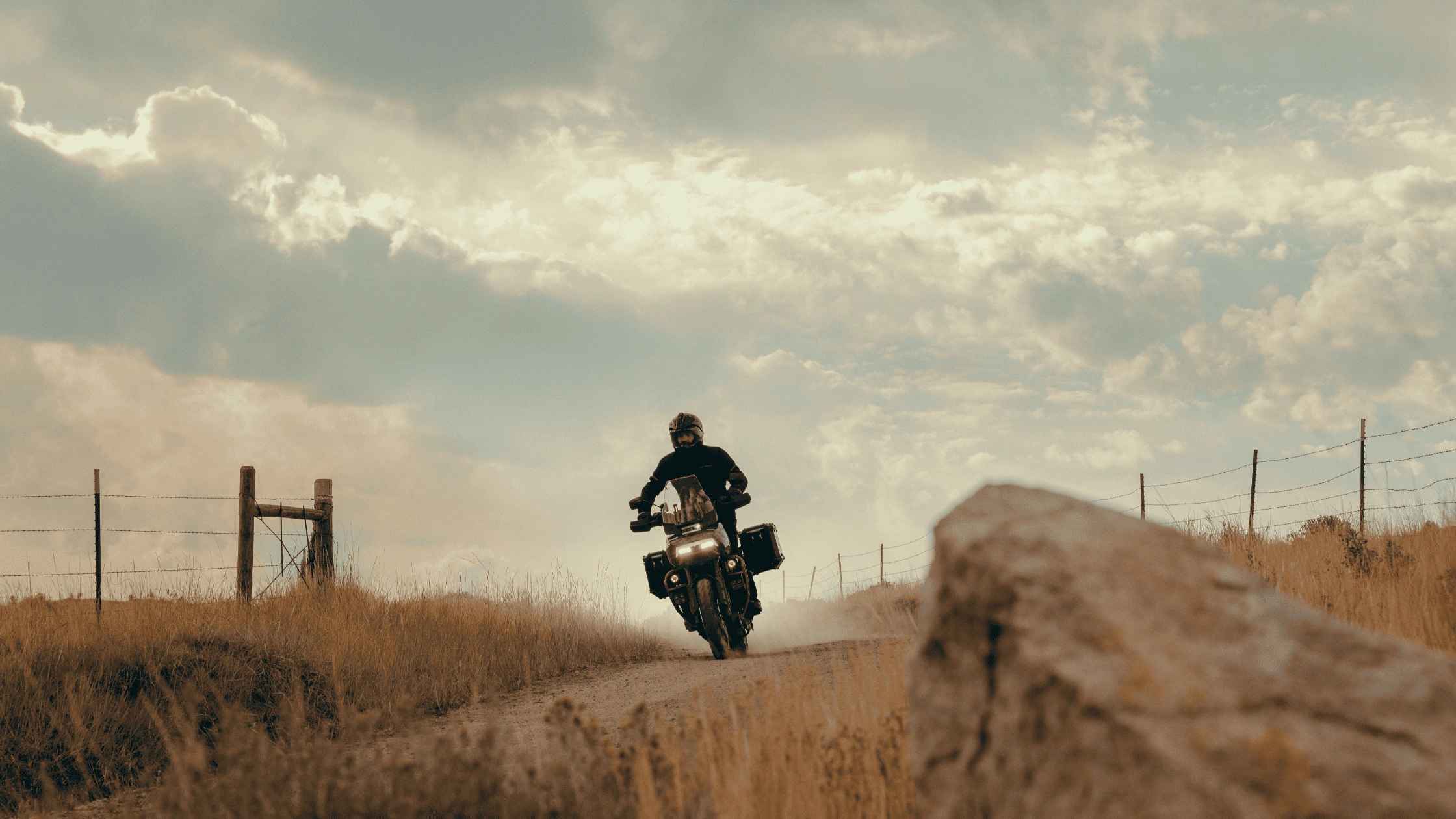 2025 CVO™ Pan America® riding on a dirt trail as the rider accelerates through rugged open terrain.