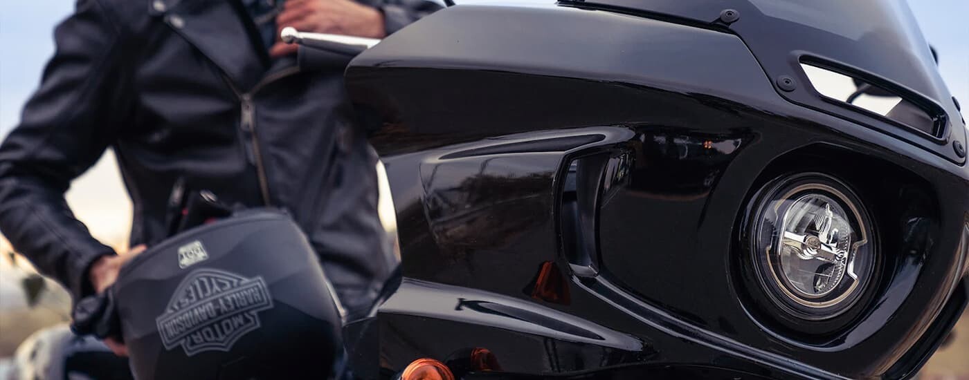 A close up of the front and headlight of a black 2022 Harley-Davidson Low Rider ST is shown.