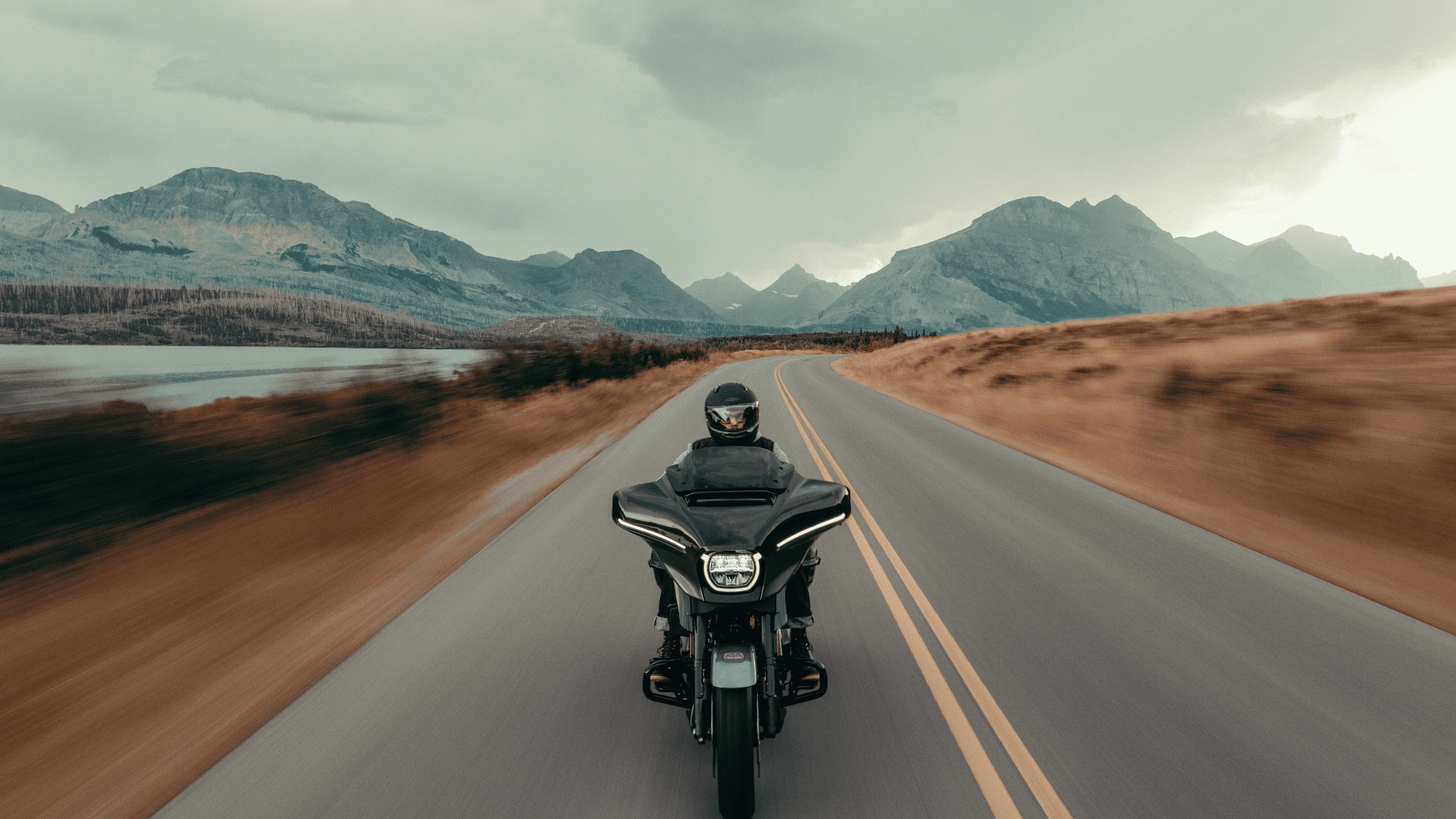 2025 Harley-Davidson® CVO™ Street Glide® cruising on a scenic highway, highlighting its premium touring setup and advanced infotainment features for Baton Rouge riders.