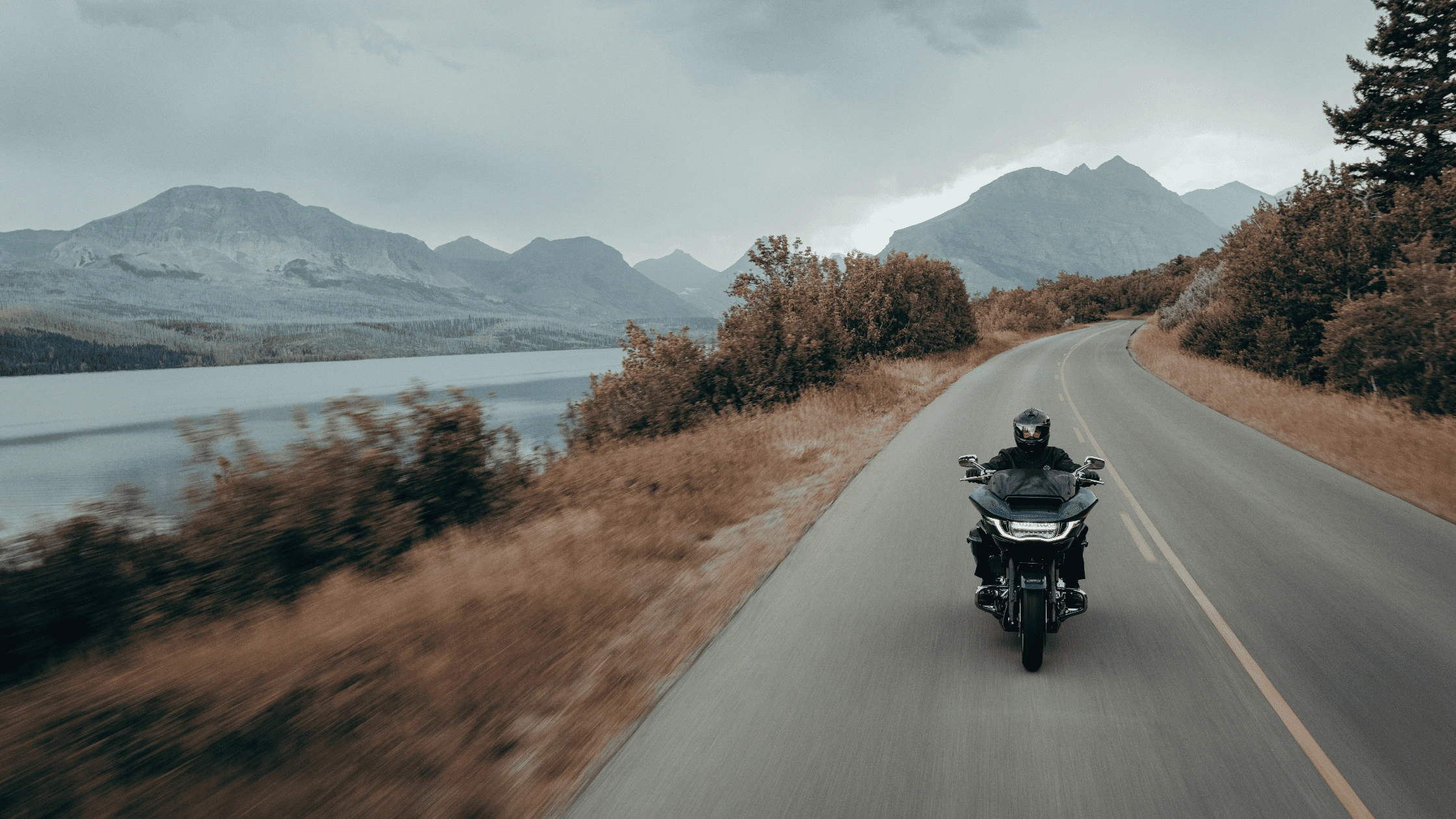 2025 Harley-Davidson® CVO™ Road Glide® riding through a mountain landscape, showcasing aerodynamic fairing design and long-distance touring performance.