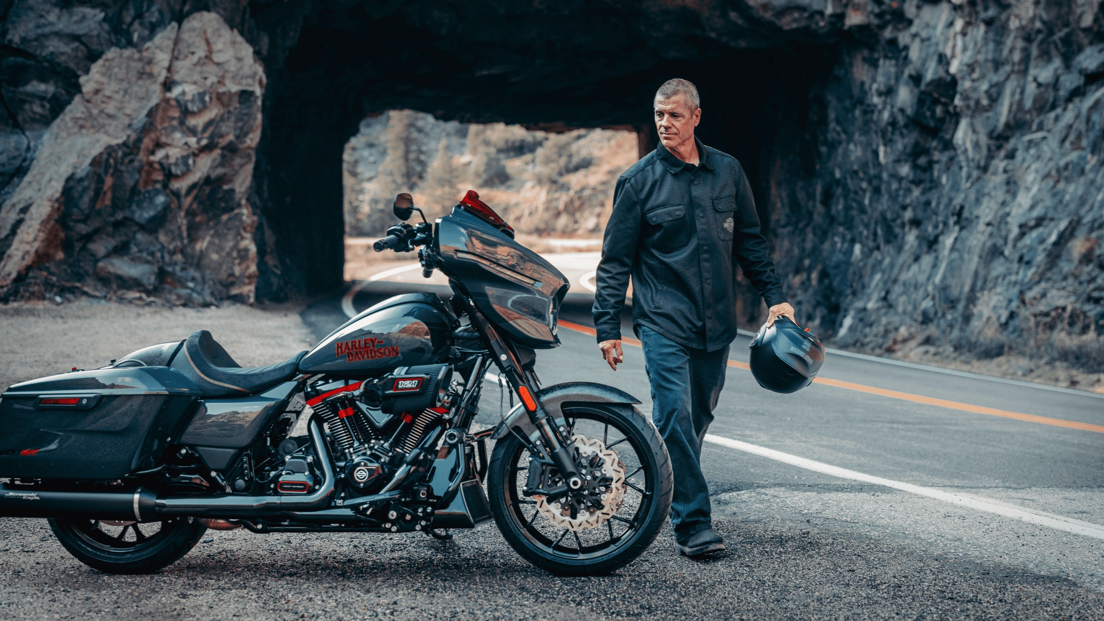 2026 Harley-Davidson CVO Street Glide ST motorcycle riding through scenic mountain roads near Bentonville, AR, highlighting premium touring performance and aggressive styling.