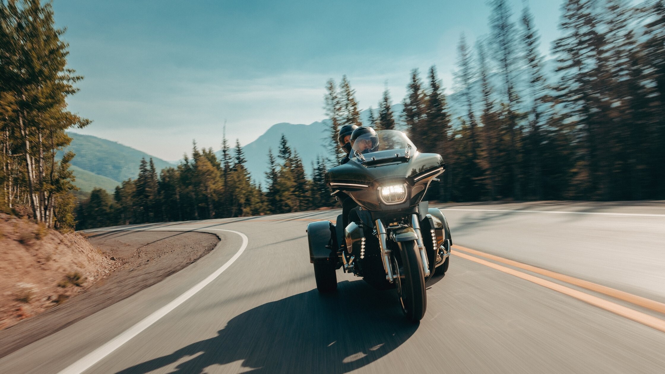 2026 Harley-Davidson® Street Glide® 3 Limited in orange rolling through urban neighborhood