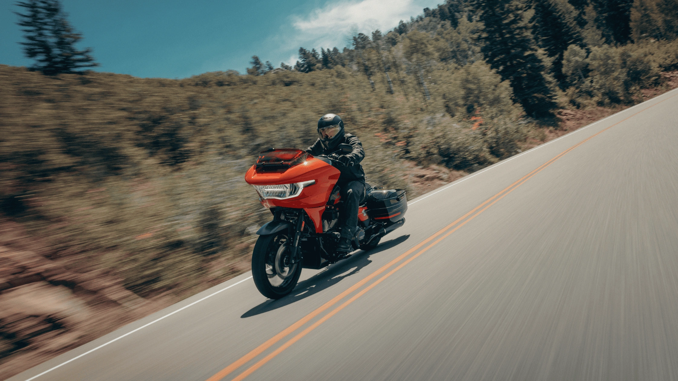 2026 Harley-Davidson CVO Road Glide ST riding along a winding road in Baton Rouge, LA, highlighting a powerful touring motorcycle built for long-distance rides.