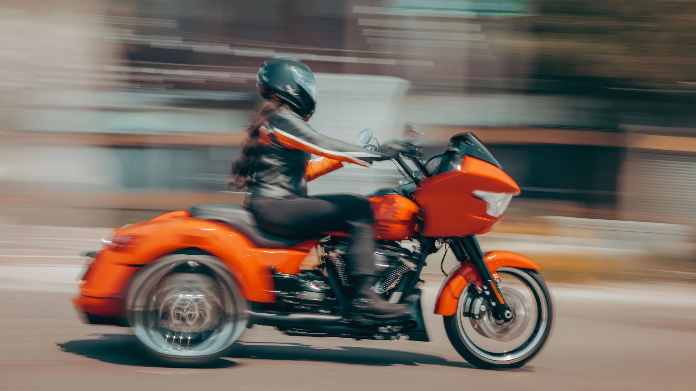 2026 Harley-Davidson® Road Glide® 3 trike front view riding on mountain highway with two riders.