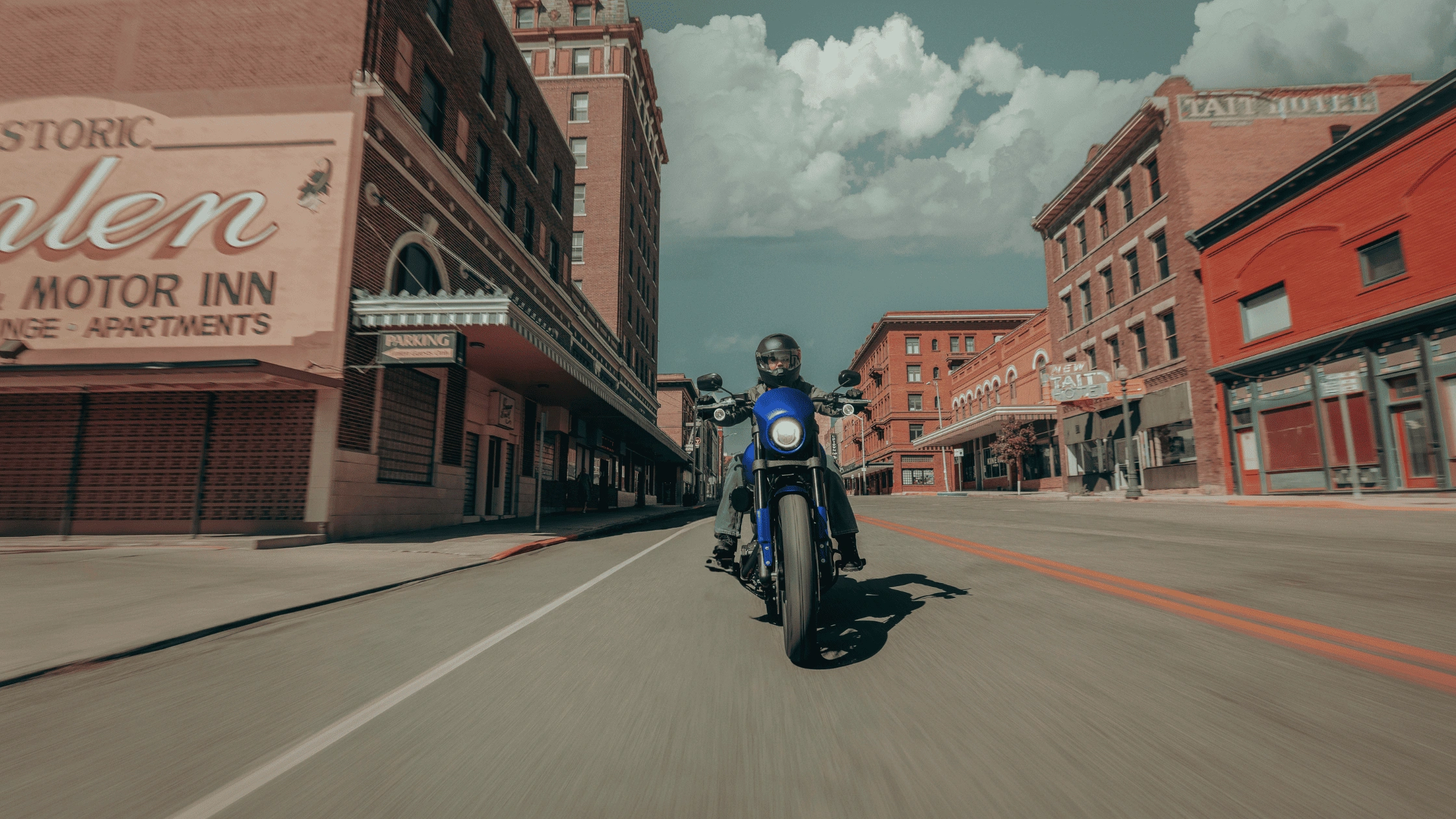 Rider leaning into a turn on a white 2026 Harley-Davidson Low Rider ST touring motorcycle in Baton Rouge, Louisiana.