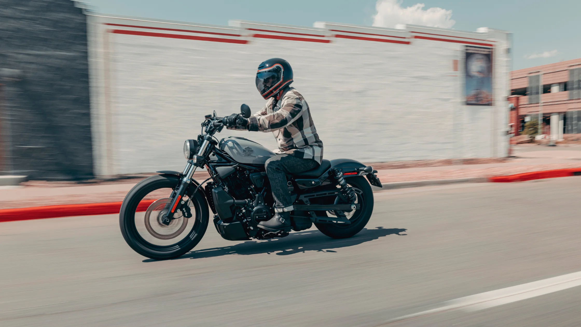 2026 H-D® Nightster® cruiser motorcycle rider cruising through downtown street