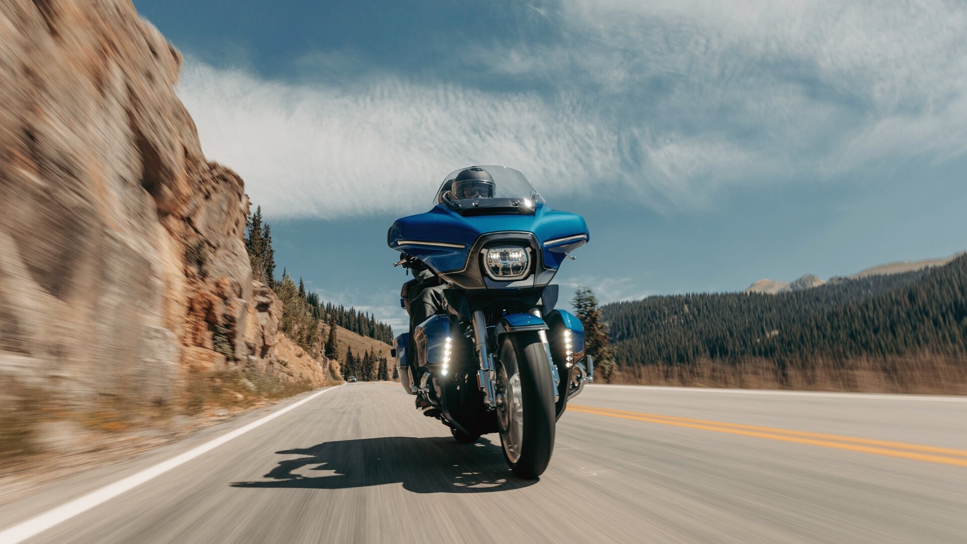2026 Harley-Davidson® CVO™ Street Glide® Limited touring motorcycle riding through a scenic mountain highway.