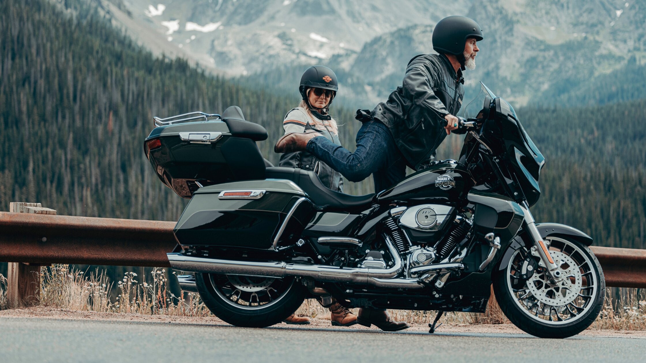 2026 Harley-Davidson® Street Glide® Limited touring motorcycle parked along a mountain roadside overlook with riders.