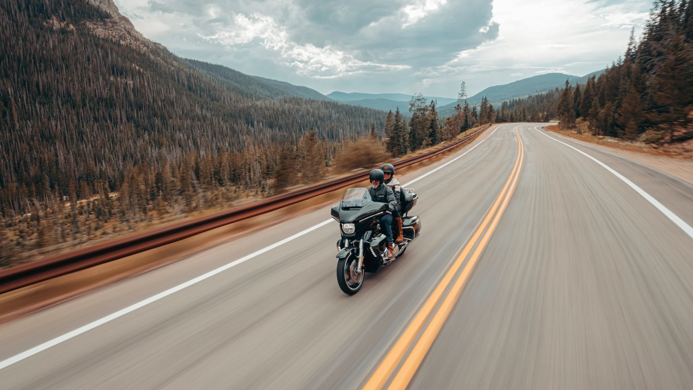 2026 H-D® Street Glide® Limited riding through a mountain highway with two riders