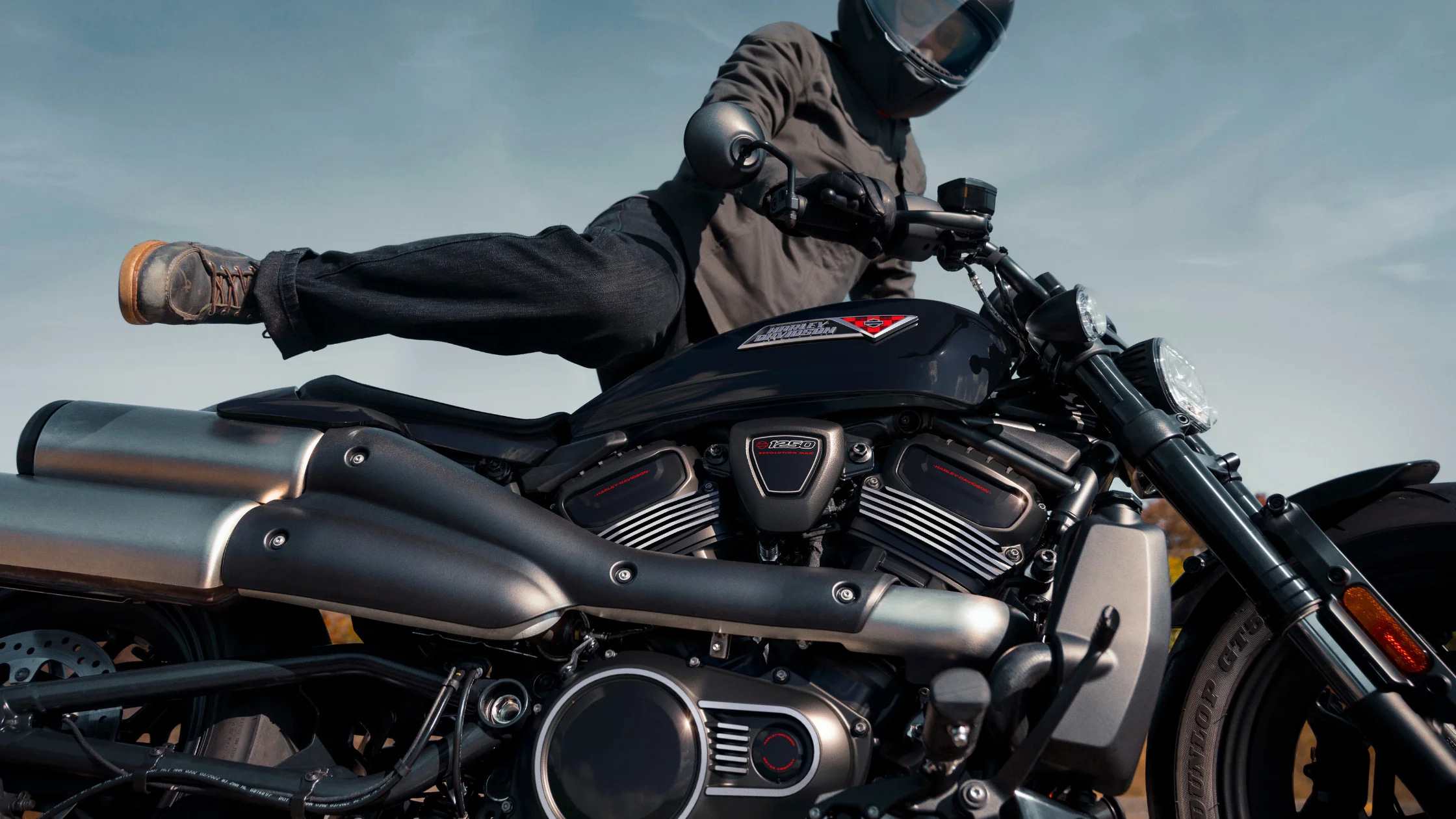 Rider mounting a 2026 Harley-Davidson® Sportster® S motorcycle outdoors