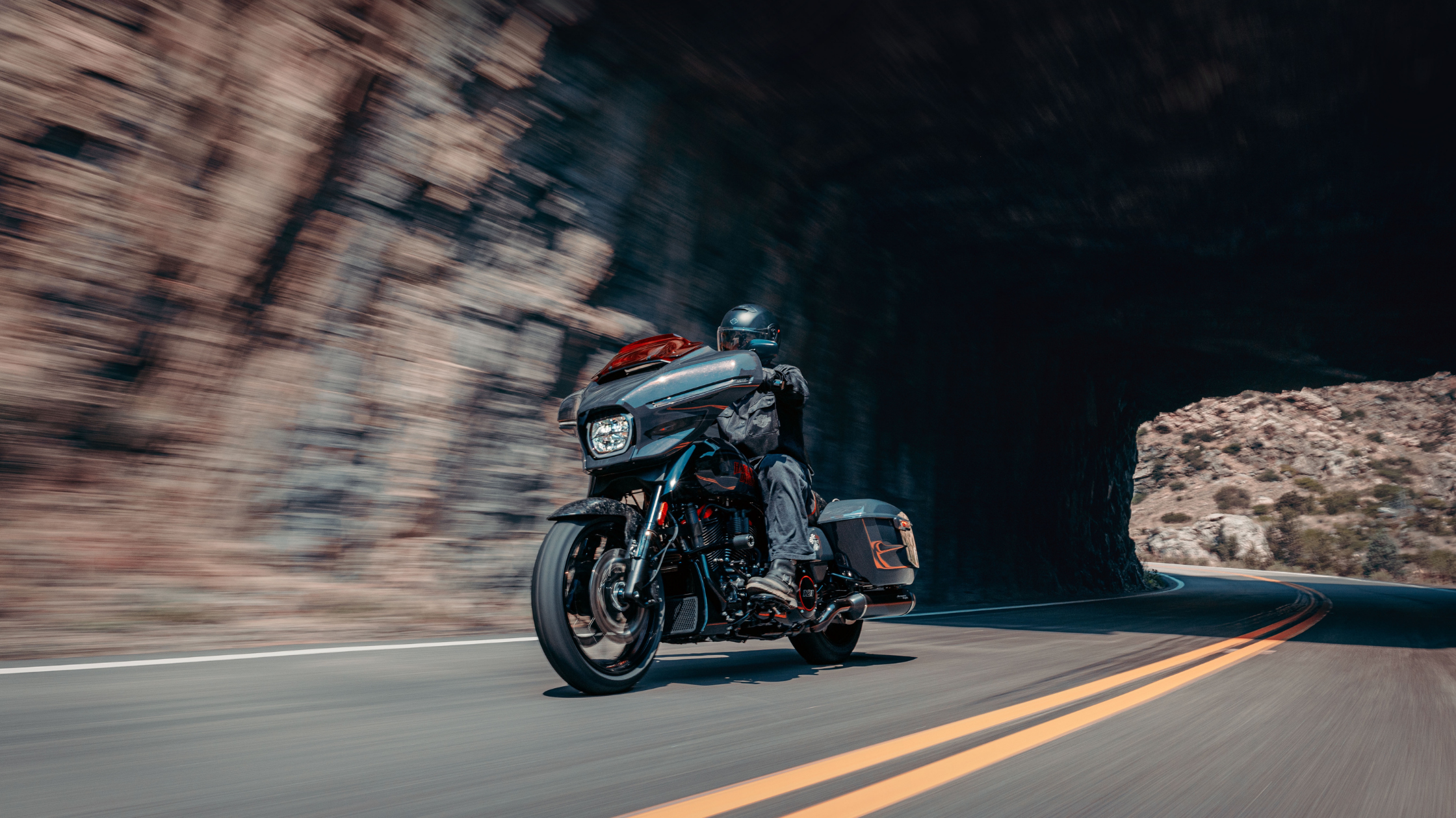 2026 CVO™ Street Glide® ST motorcycle cornering through a rocky canyon road
