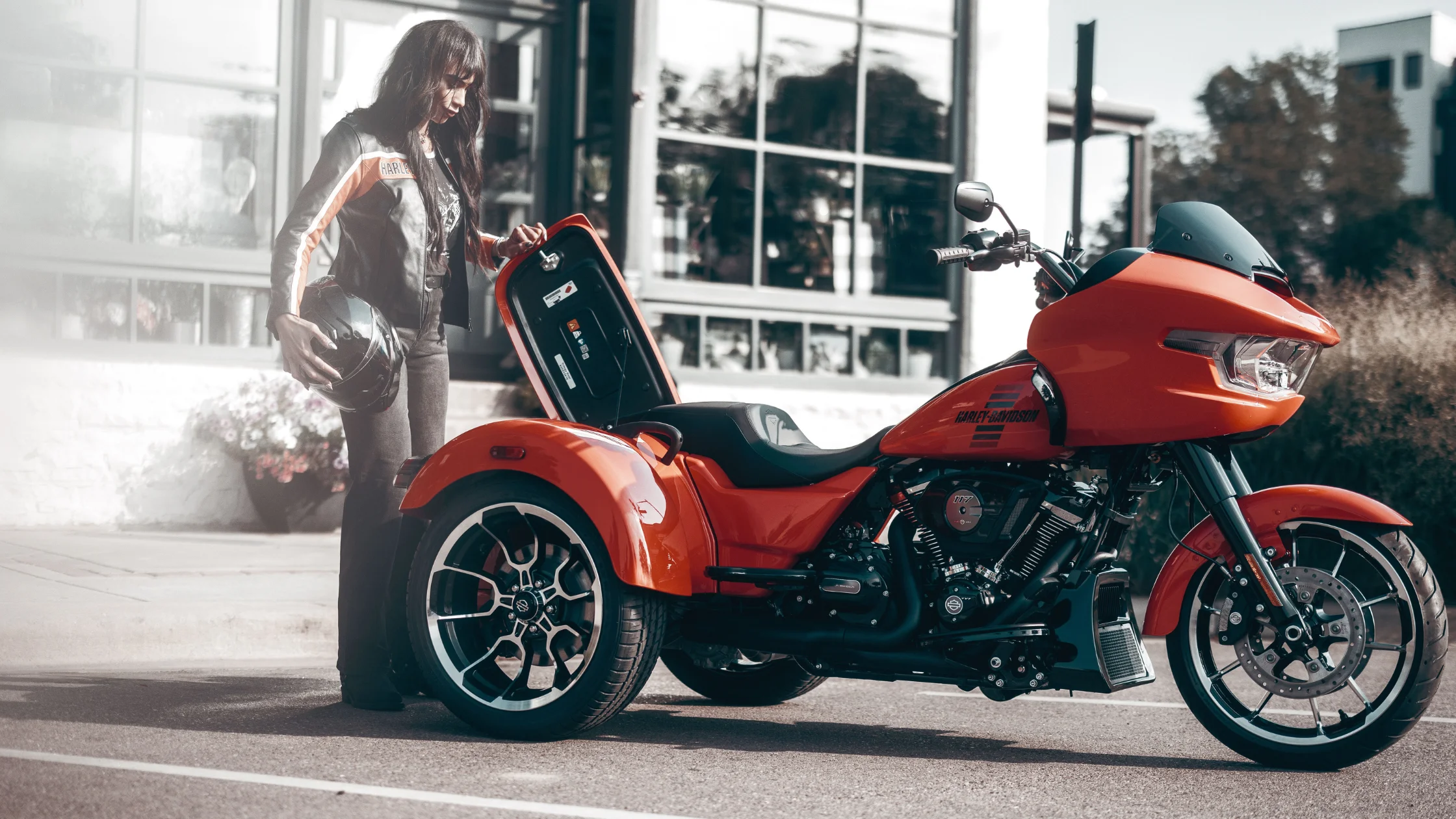 2026 H-D® Road Glide® 3 in orange parked outside with rear trunk open