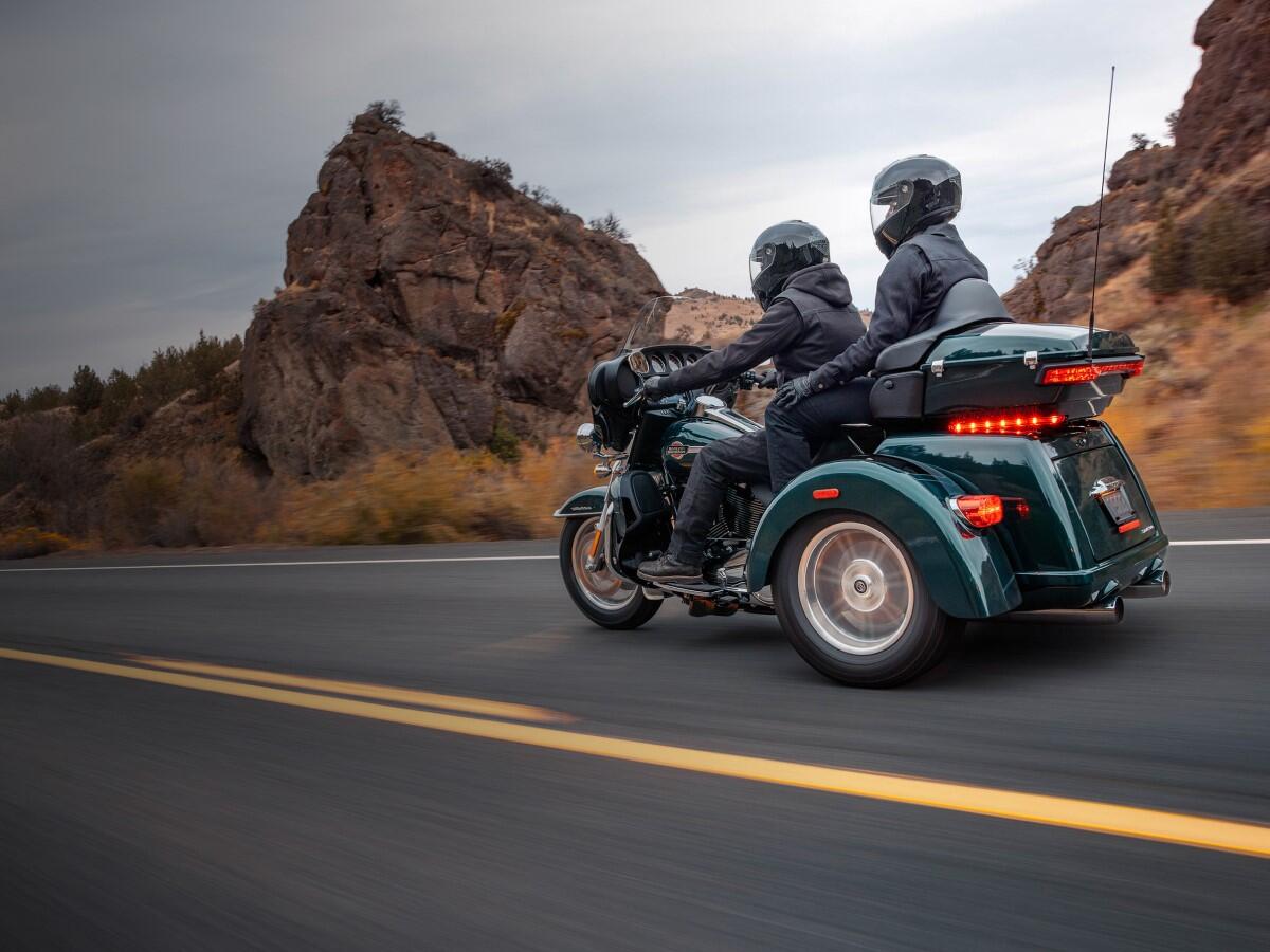 New Harley-Davidson trike cruising on highway